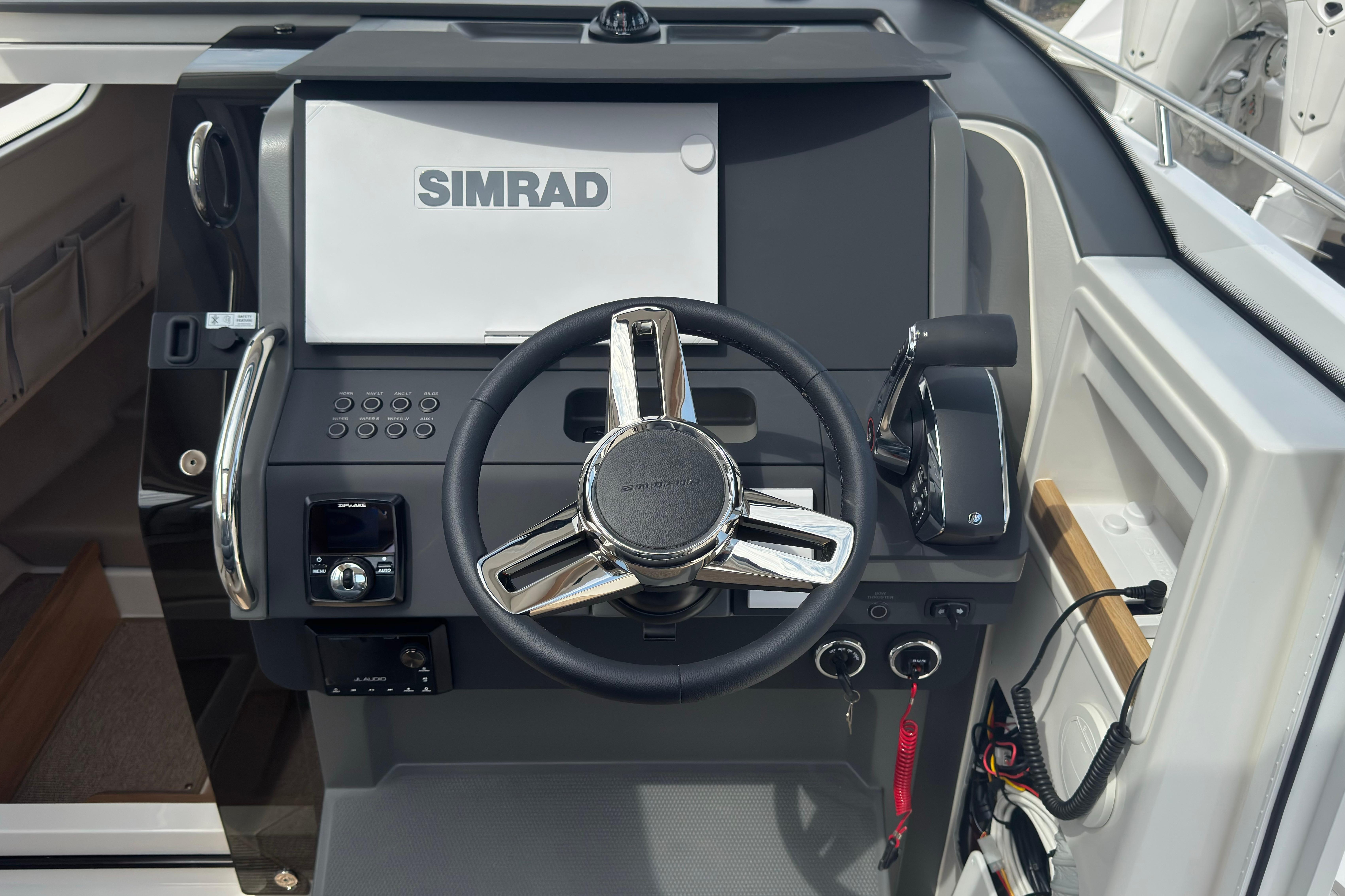 The image shows the helm of a Nimbus Commuter 9 boat with a Simrad display.