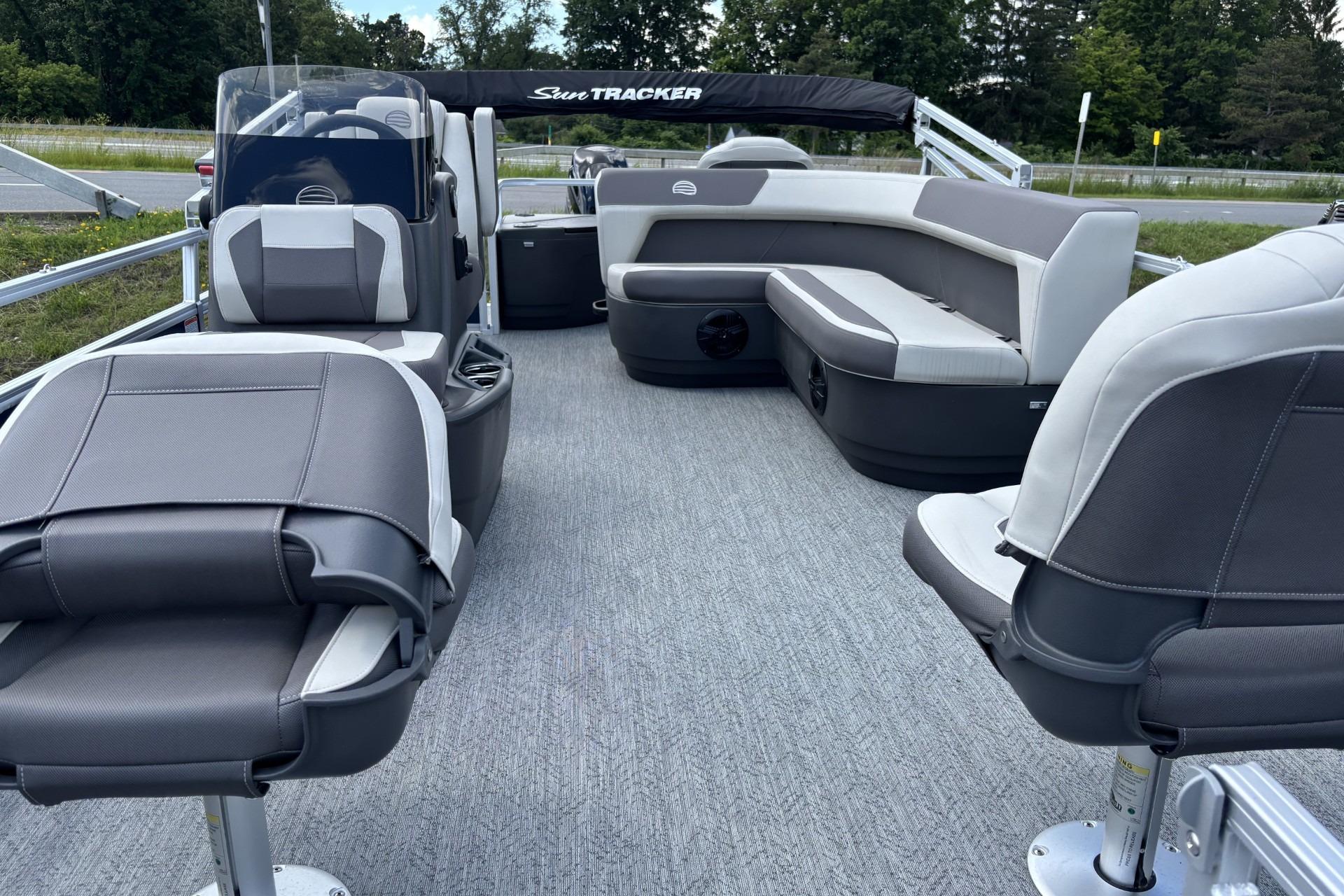 2026 Sun Tracker Bass Buggy 18 DLX pontoon boat interior with gray seating and carpet.