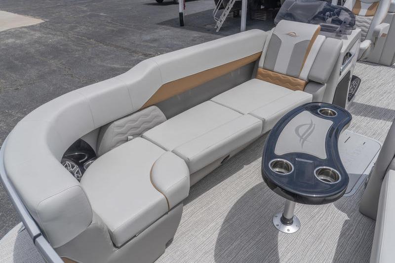 Luxurious seating area on 2026 SunCatcher Elite 326 SS pontoon boat with sleek design.