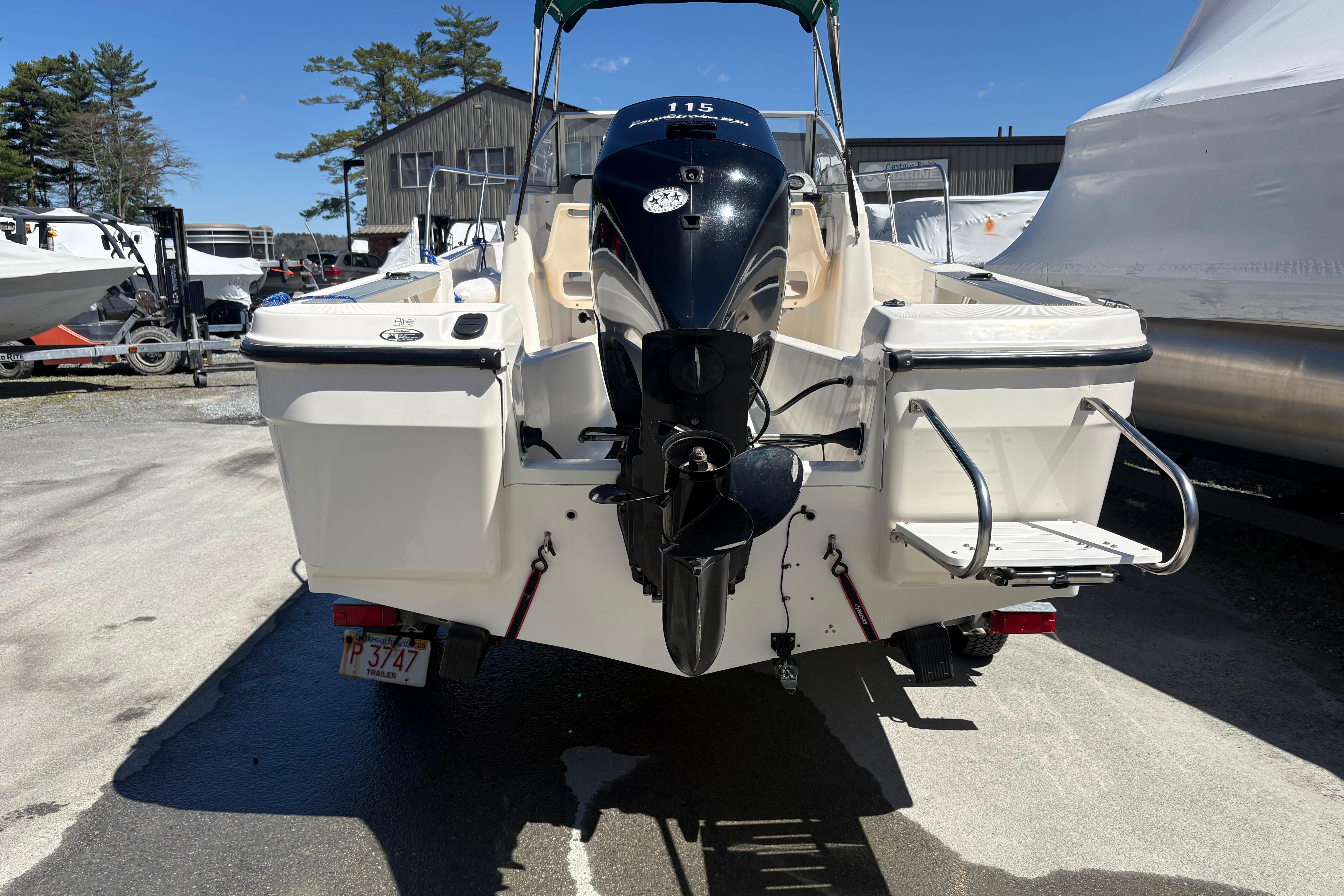 2004 Trophy 1802 Walkaround boat with outboard motor, parked outdoors.