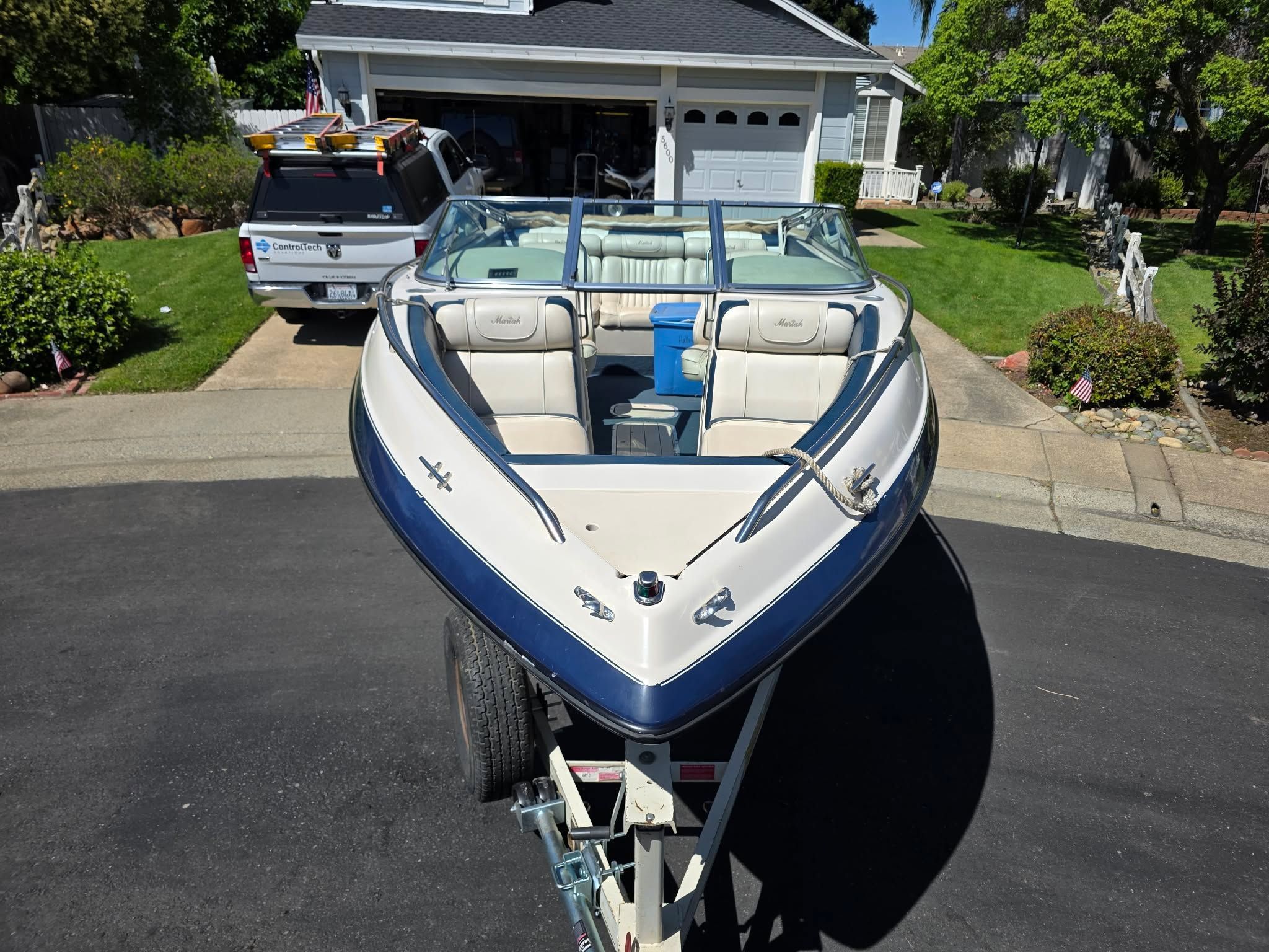 1996 Mariah Talari boat on trailer parked in driveway.