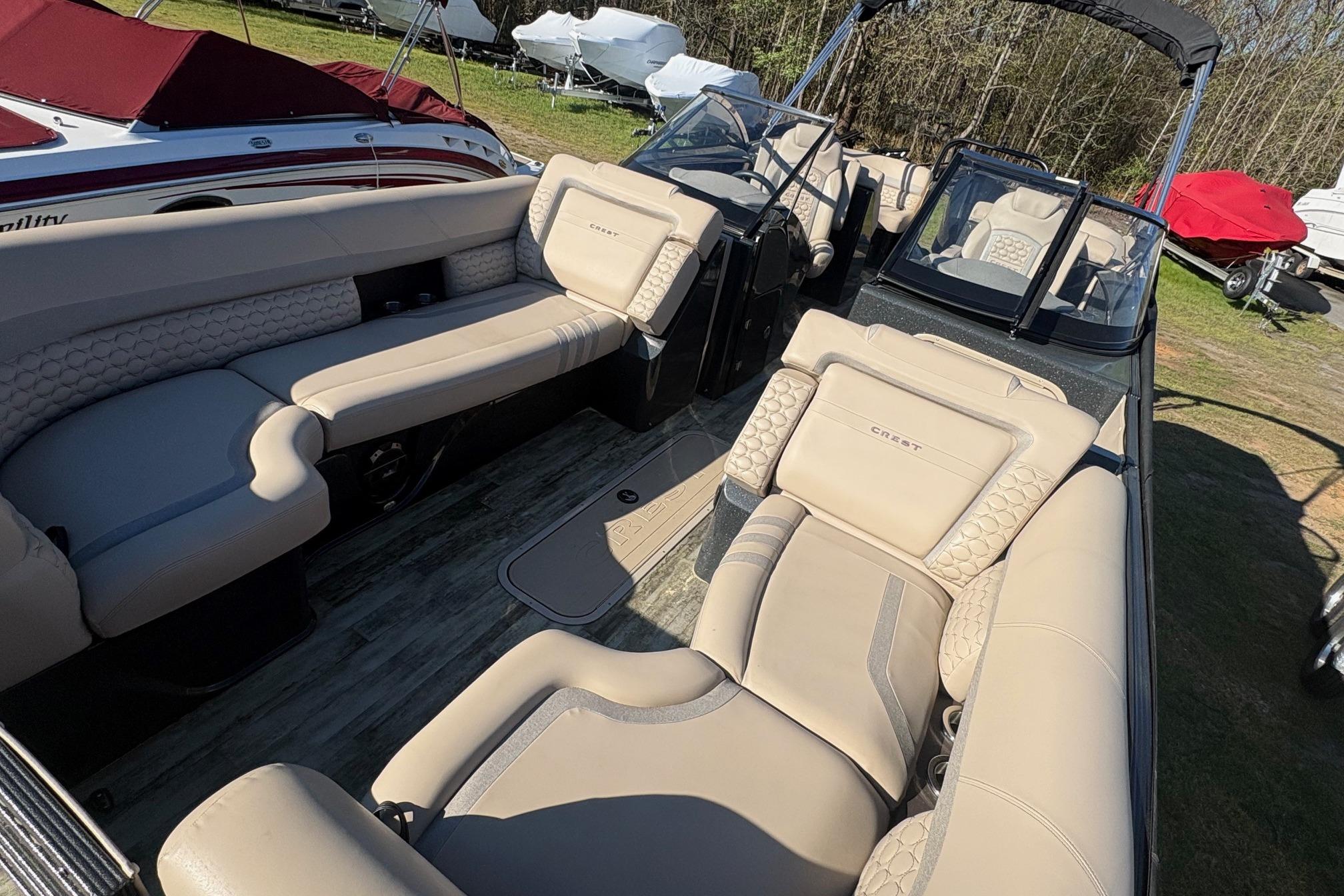 Luxurious interior of 2022 Crest Continental 250 boat with beige seating and modern design.