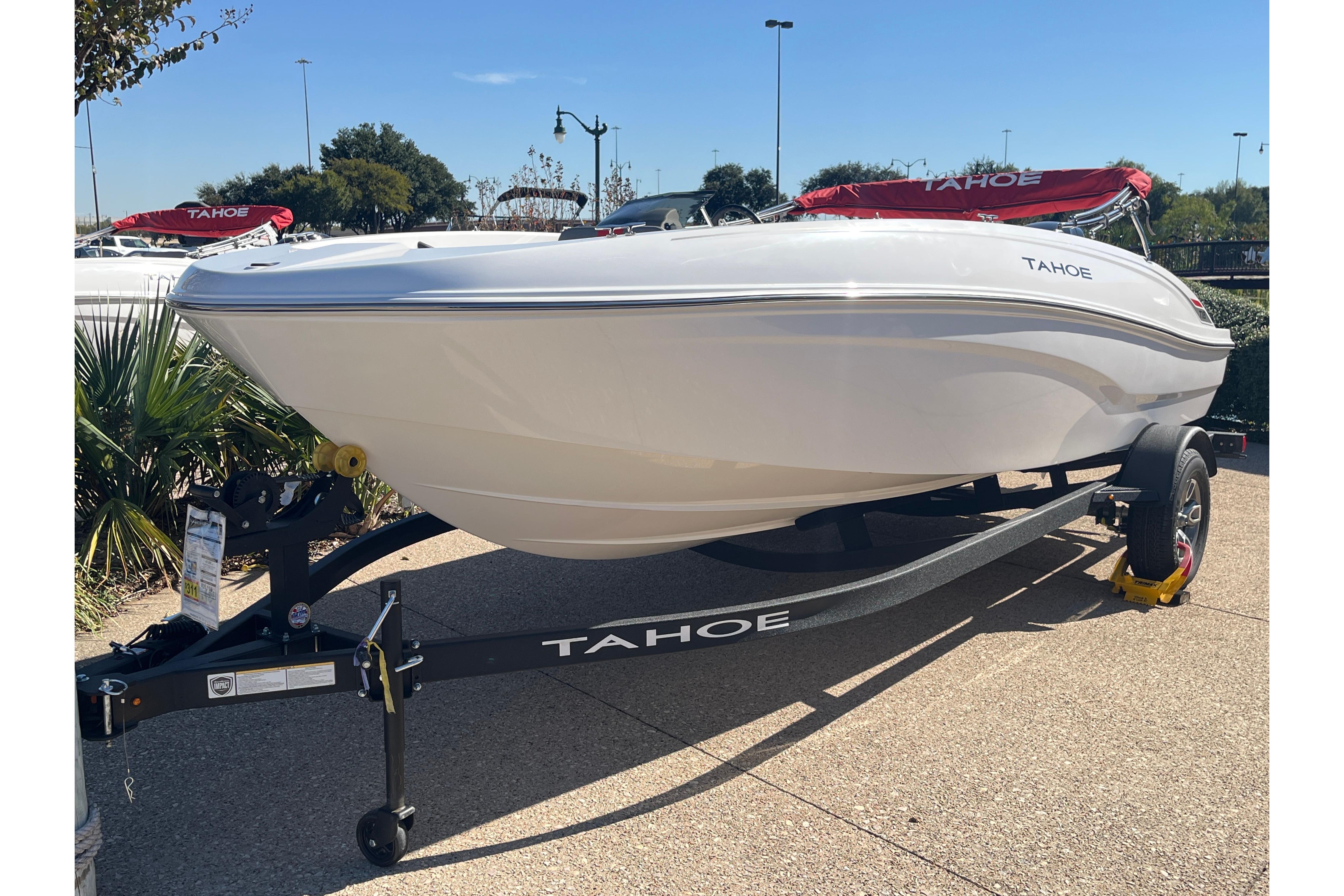 2026 Tahoe T18 boat on trailer, displayed outdoors under clear blue sky.