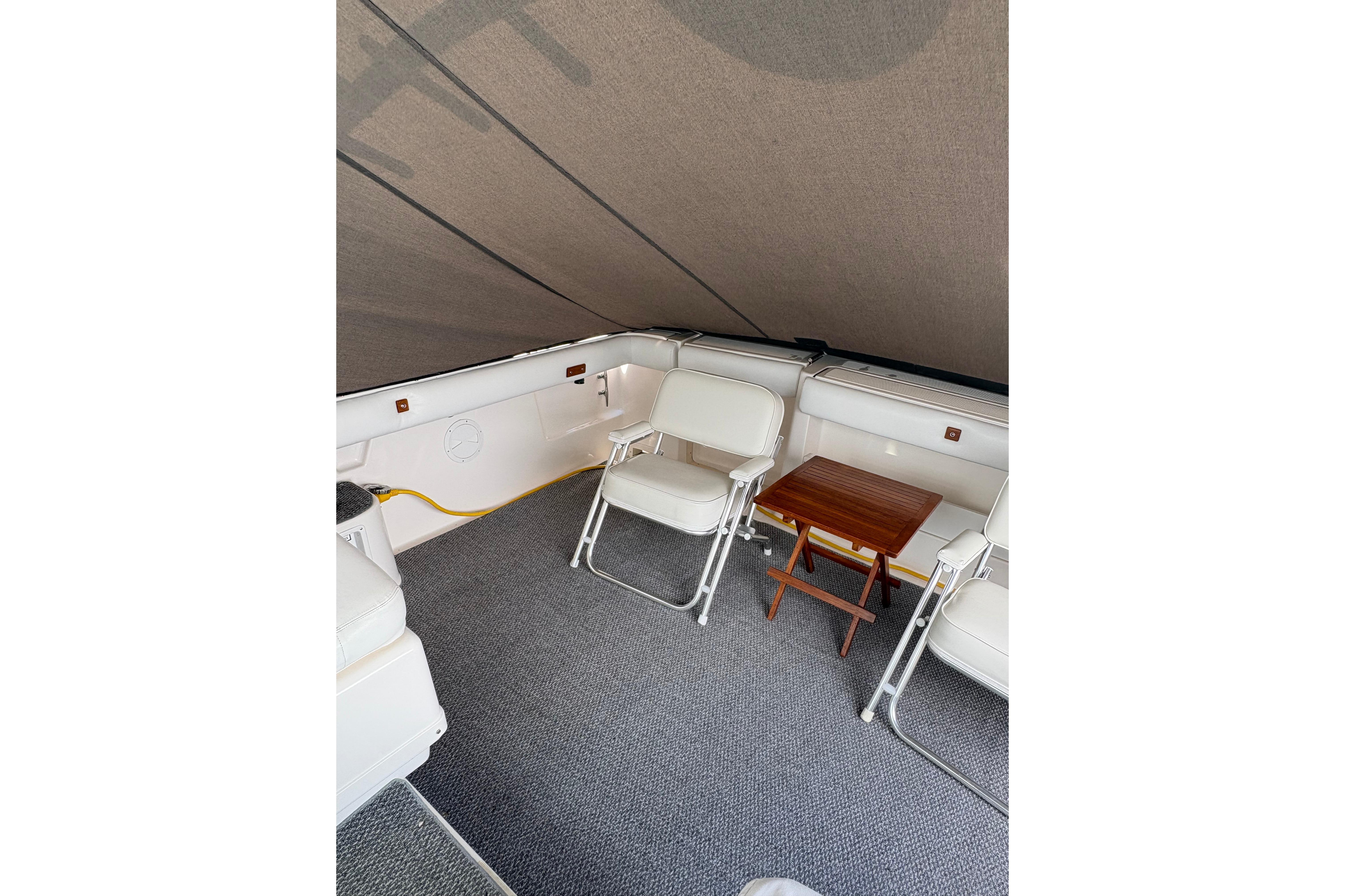 Interior of 1999 Tiara Yachts 3100 Open with seating and small wooden table.