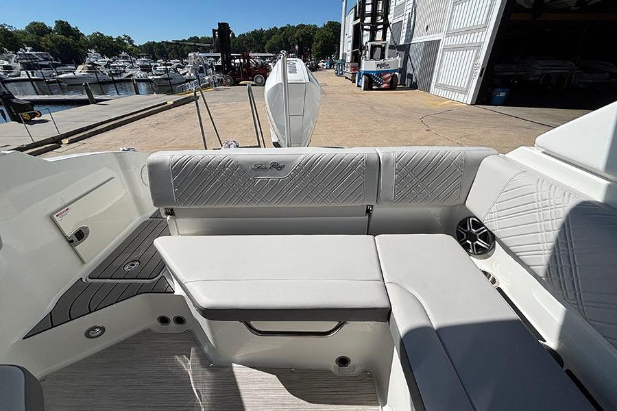 2027 Sea Ray SDX 230 Outboard boat interior with white seating at marina.