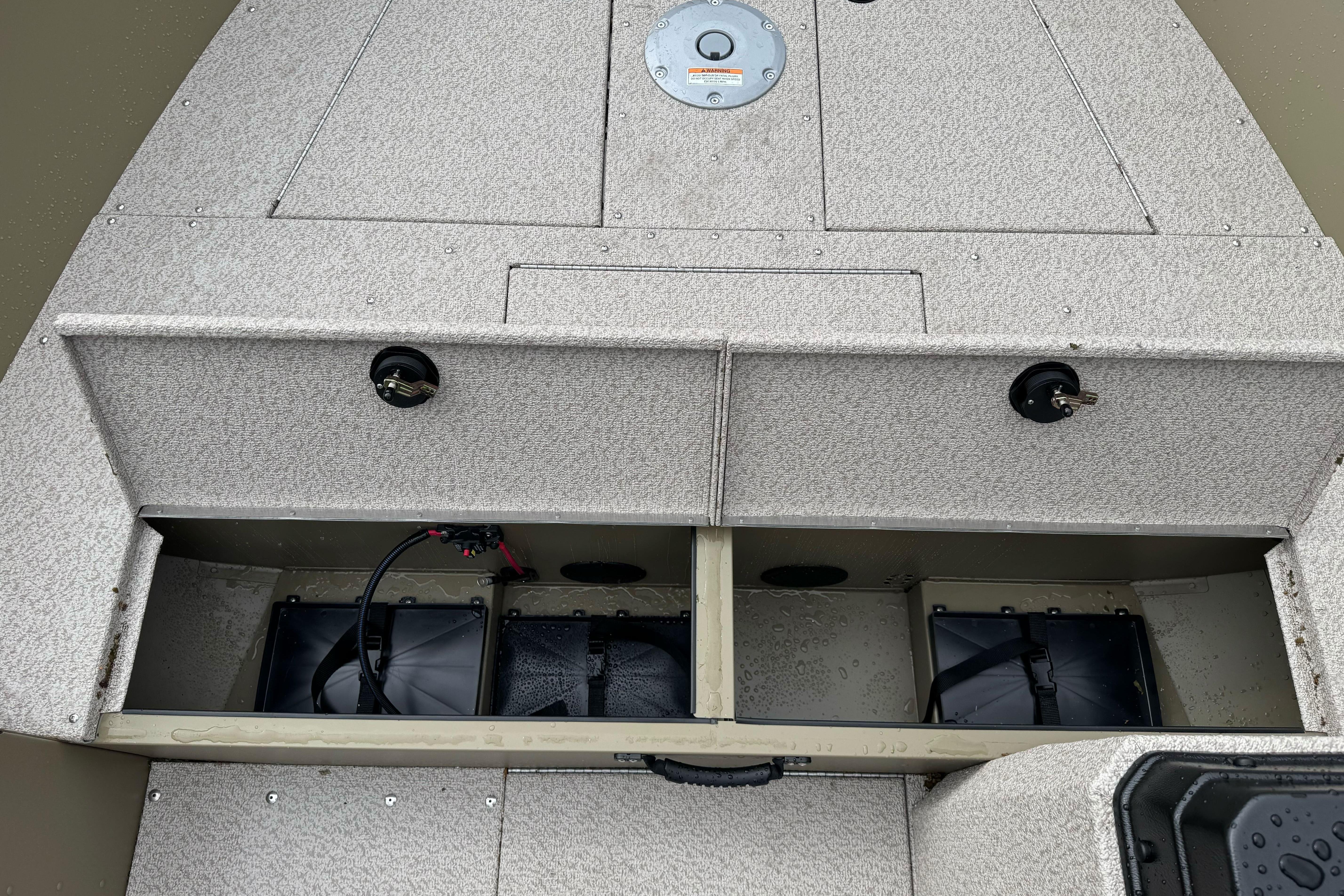 2026 Lund 2075 Alaskan SS boat interior with storage compartments and battery setup.