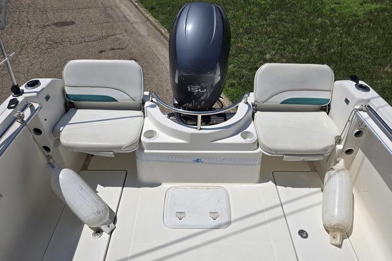 2004 Aquasport 215 Osprey Sport boat with dual seats and outboard motor.