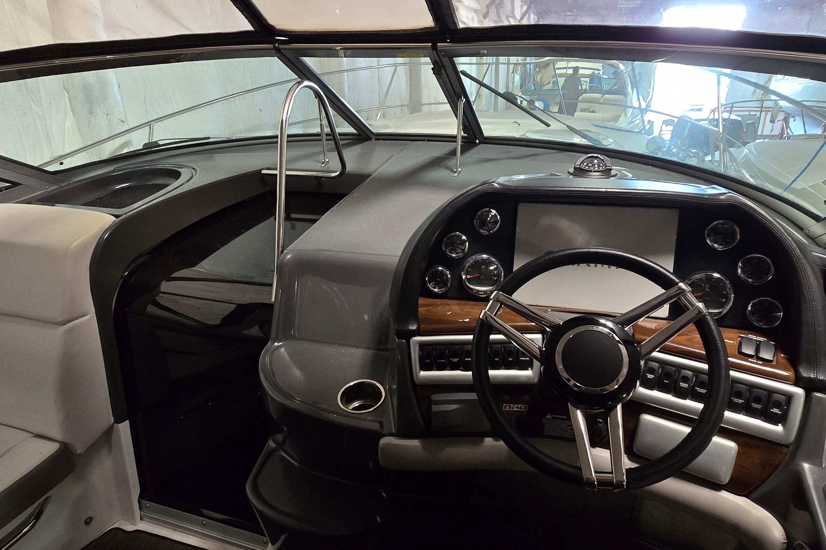 2018 Four Winns V355 boat cockpit with steering wheel and control panel.