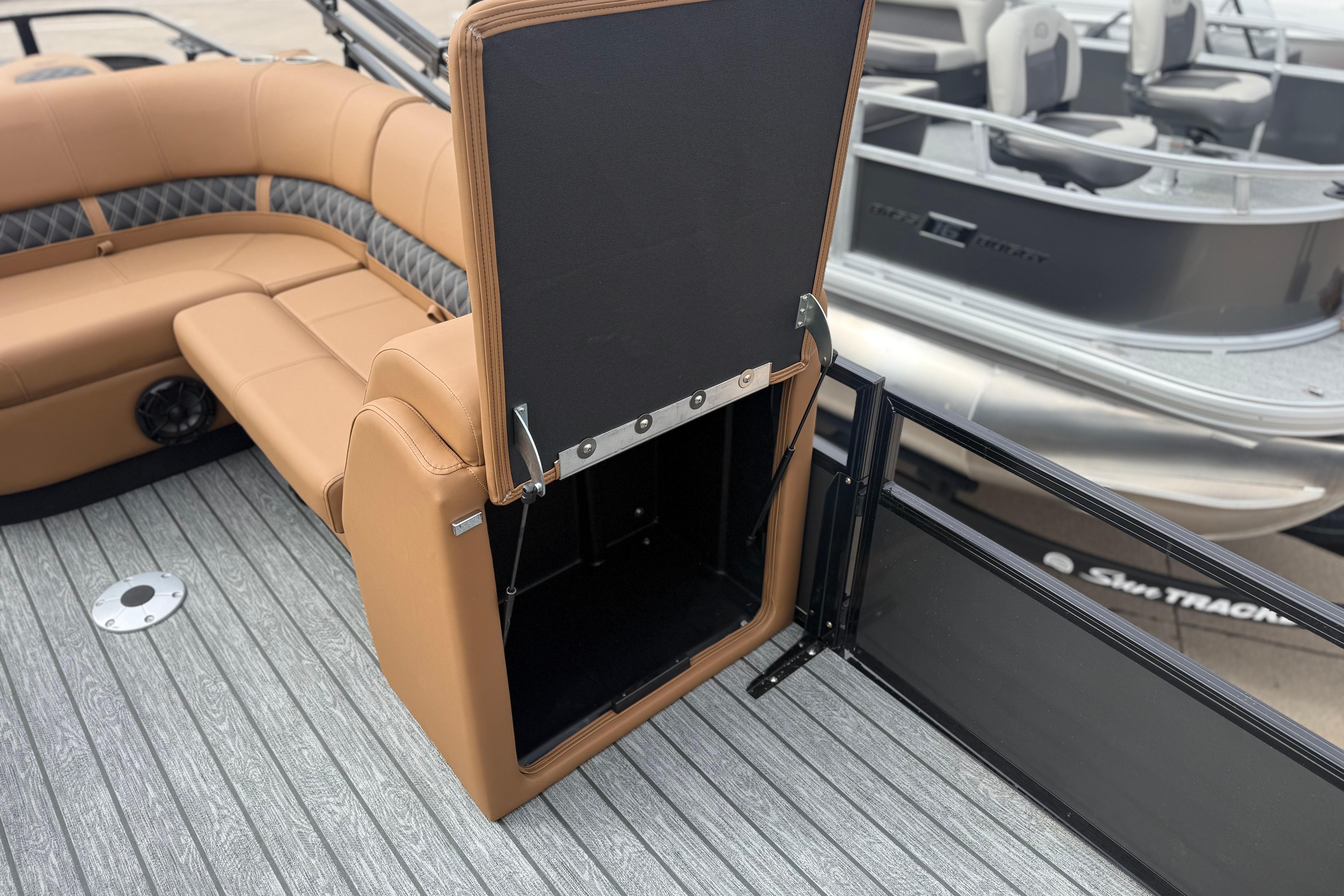 2026 Ranger 220F boat interior with tan seating and storage compartment open.