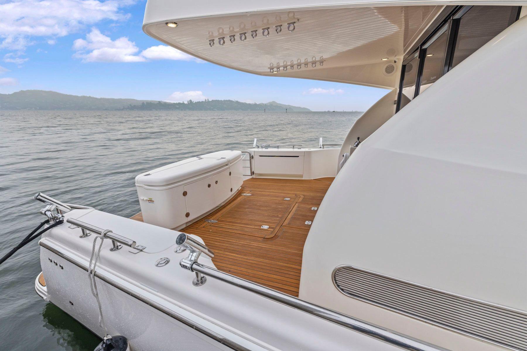 2014 Maritimo M50 yacht with teak deck, docked on calm waters.