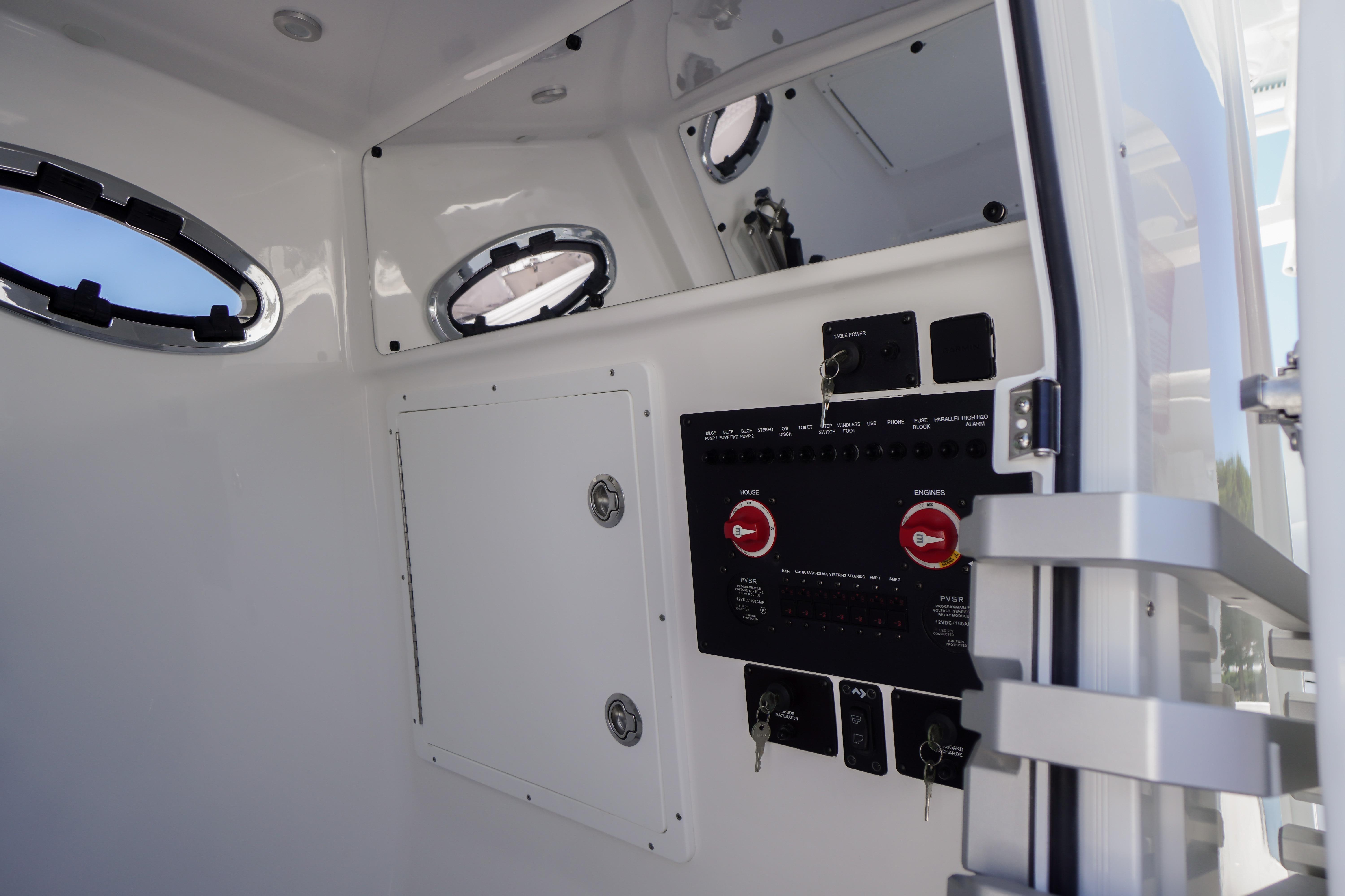 Interior view of 2026 Tidewater 302 CC Adventure boat's control panel and portholes.