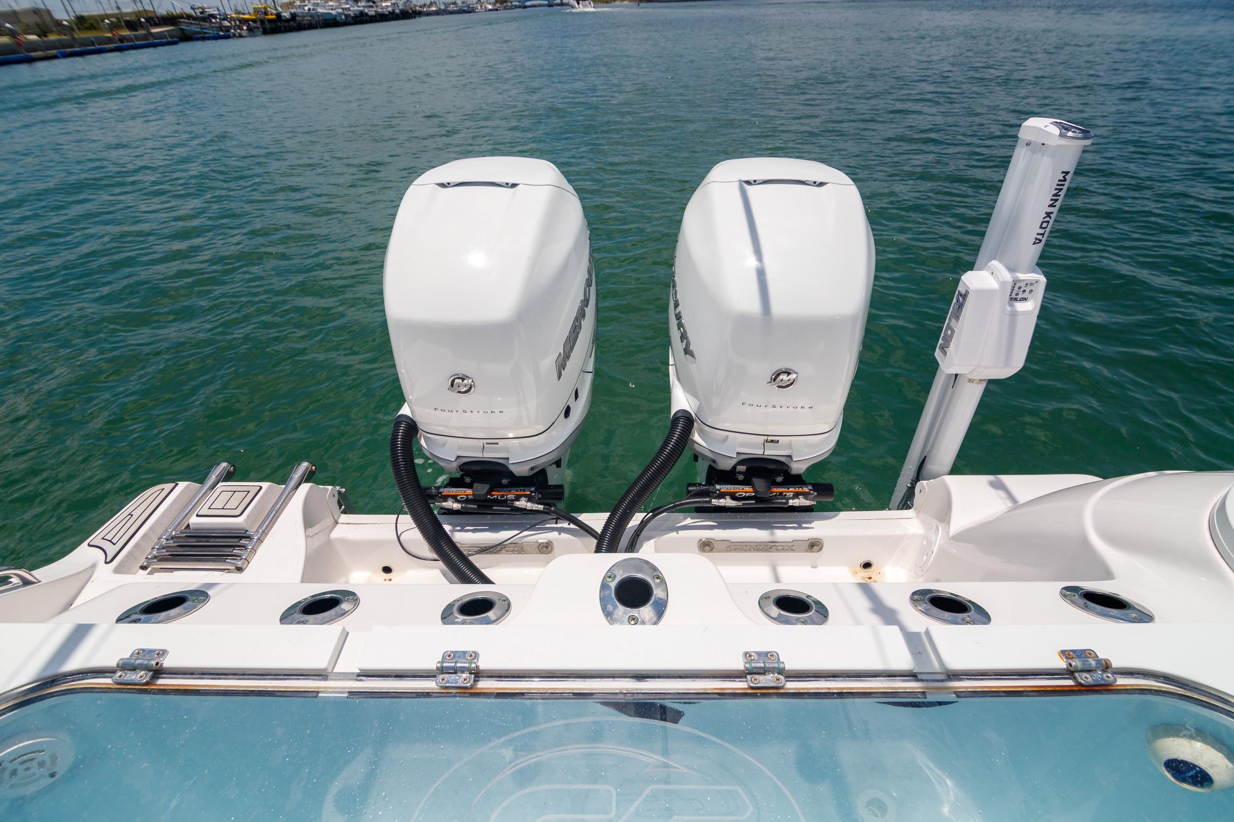 2021 Sea Fox 328 Commander with dual Mercury outboard engines on calm water.