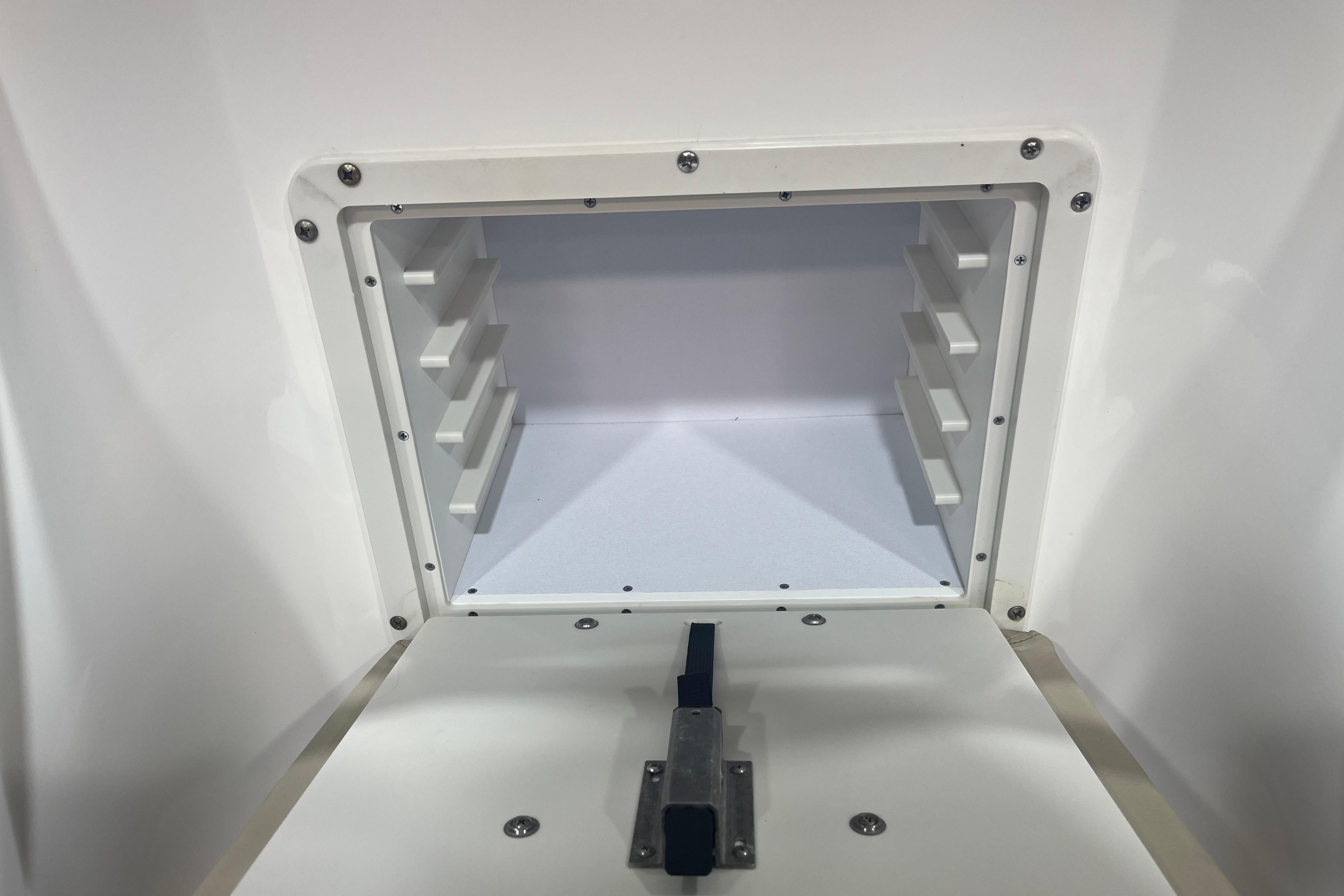 Storage compartment of 2023 NauticStar 227 XTS boat, featuring a secure latch mechanism.