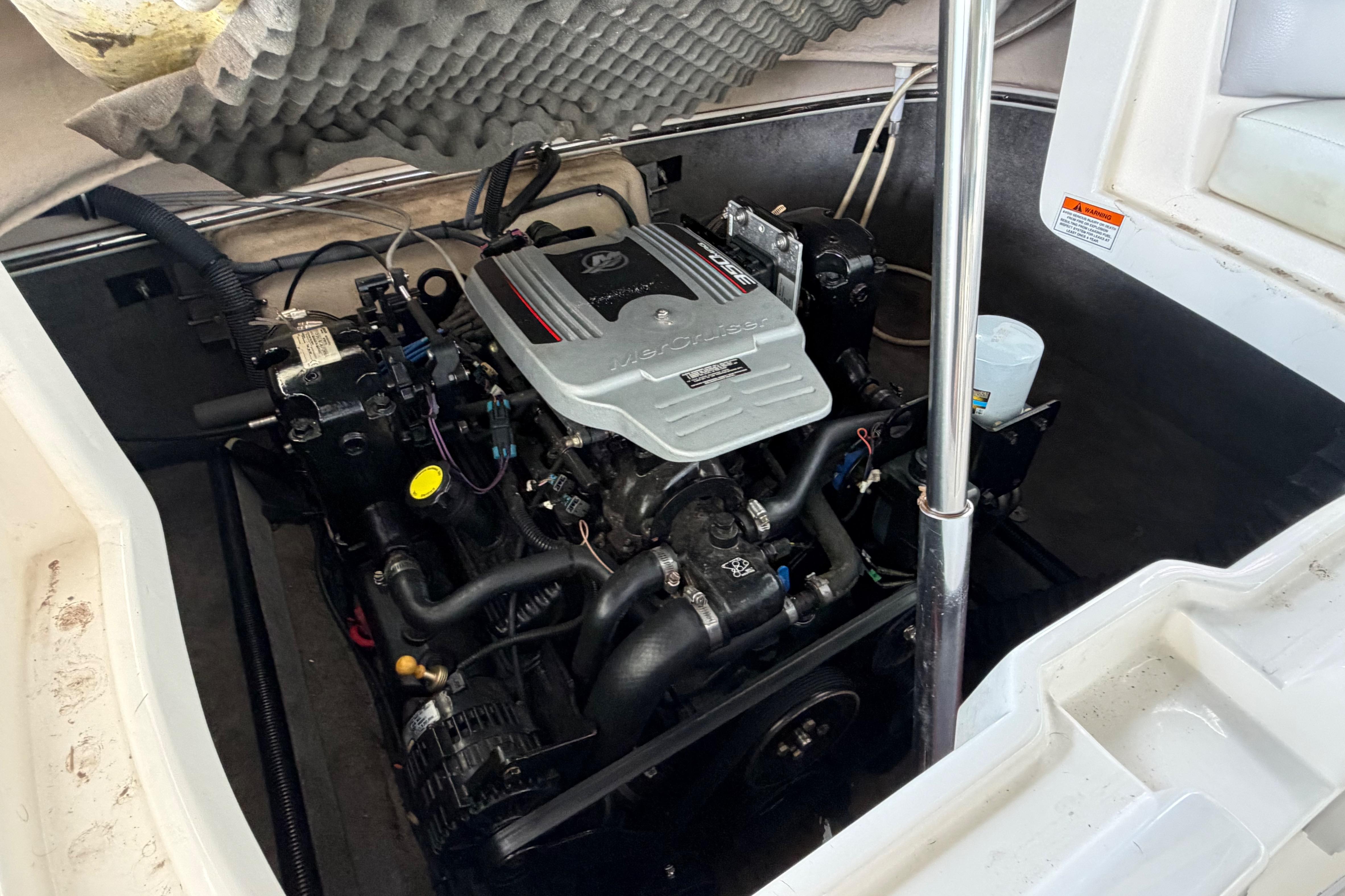 Engine compartment of a 2010 Bryant 255 boat, featuring a MerCruiser engine.