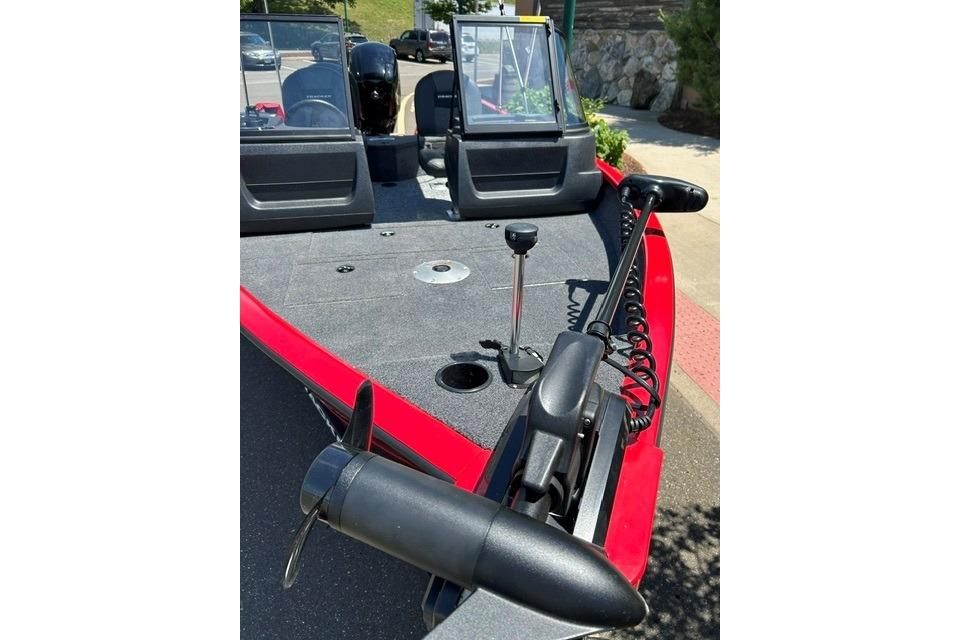 2026 Tracker Pro Guide V-16 WT boat with trolling motor and windshield, parked outdoors.