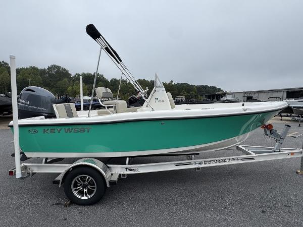 2025 Key West 179 FS boat on trailer, green hull, parked outdoors.