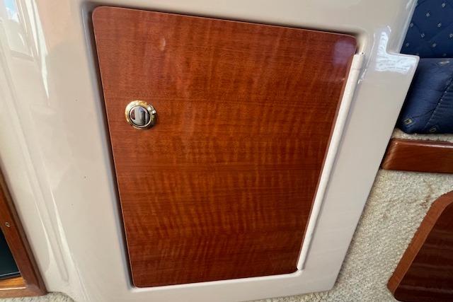 Wooden cabinet door on 2003 Sea Ray 260 Sundancer boat interior.