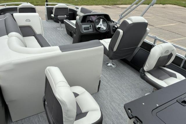 Interior of 2026 Sun Tracker Fishin' Barge 22 DLX pontoon boat with seating and helm.