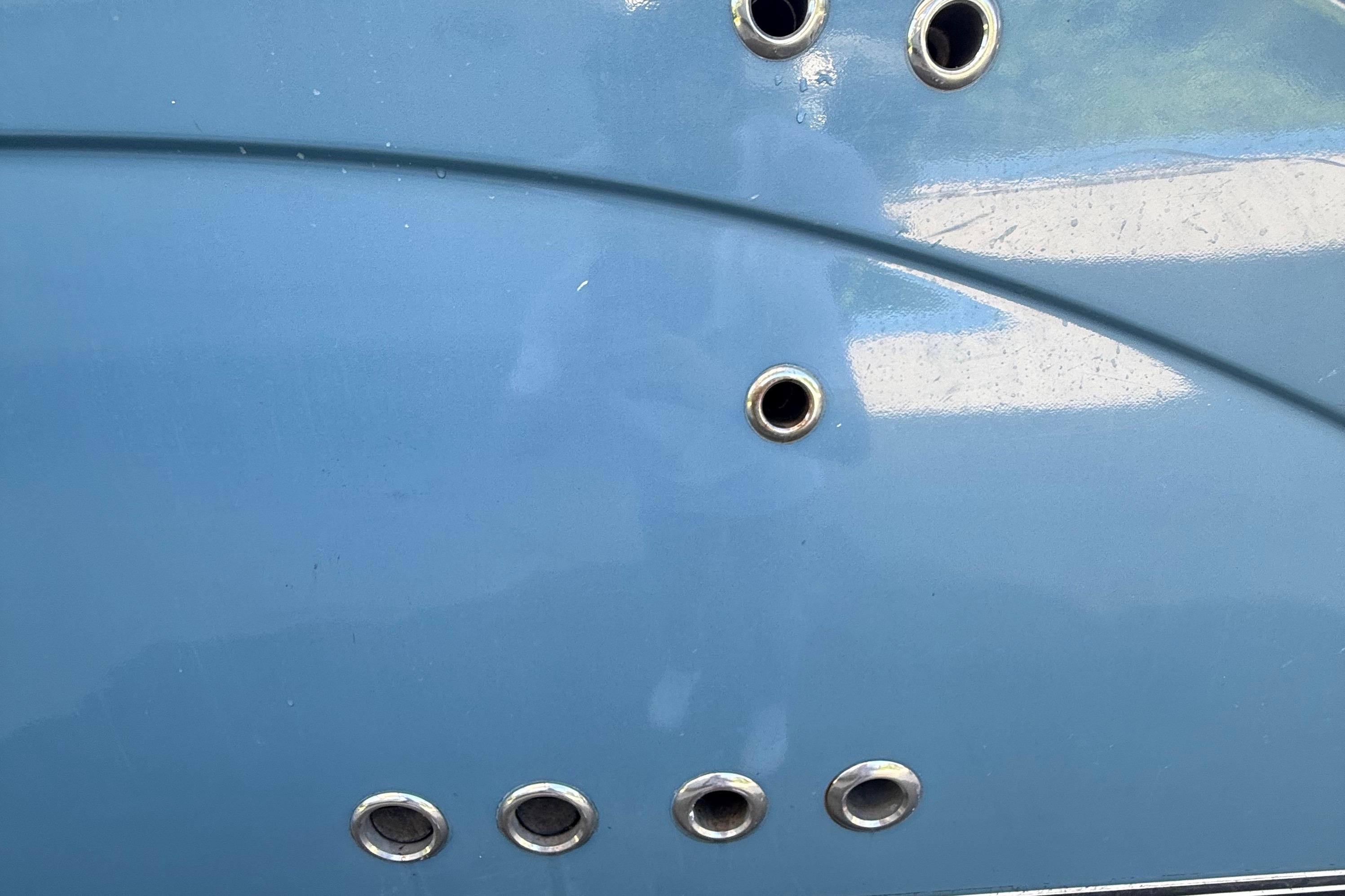 Close-up of a 2008 Century 2901 Center Console boat hull with metal fittings.