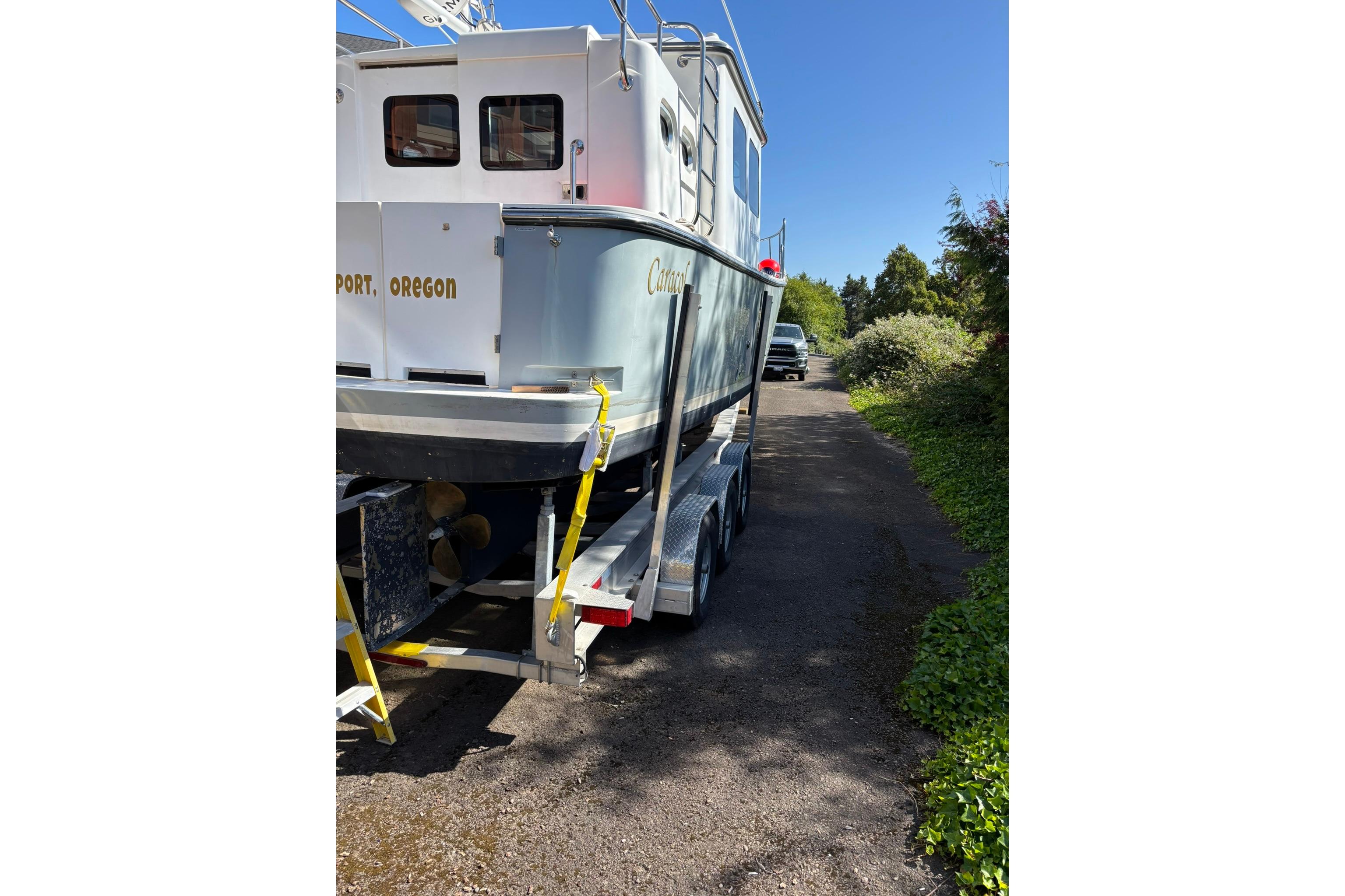 2020 SeaPiper 35 boat on trailer, parked on a sunny driveway in Oregon.