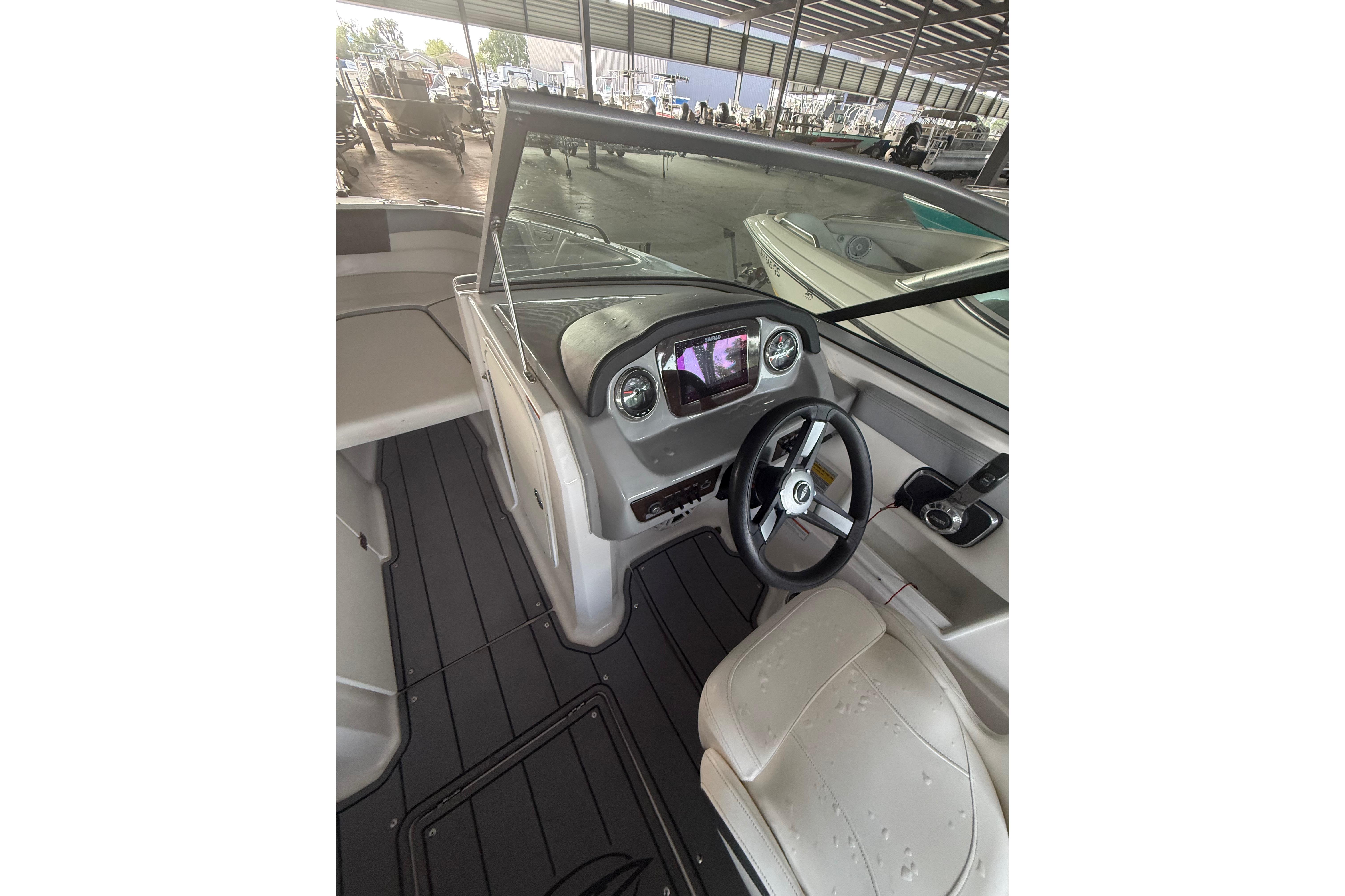 2023 Chaparral 230 SSi boat interior with steering wheel and dashboard controls.