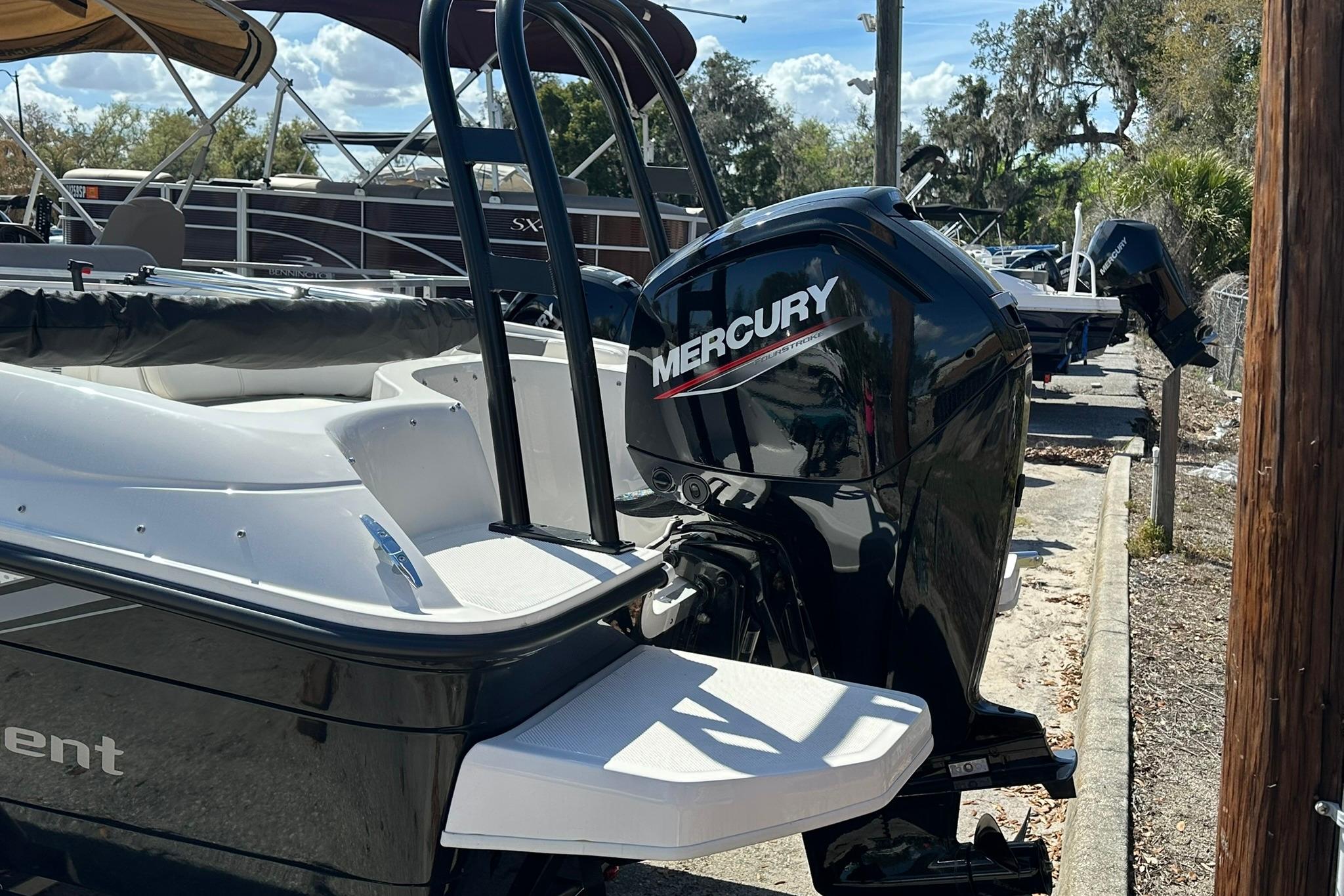 2026 Bayliner Element E18 boat with Mercury outboard motor, docked outdoors.