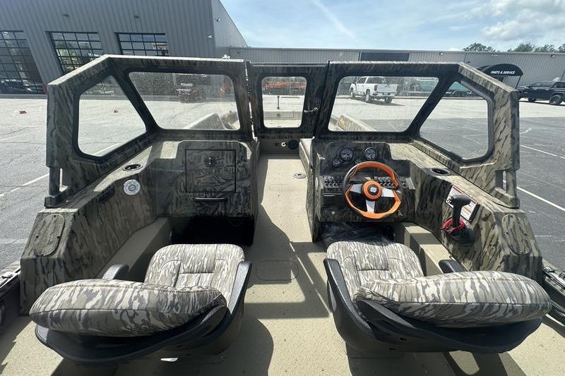 Interior of a 2026 SeaArk EasyCat boat with camouflage seating and steering wheel.