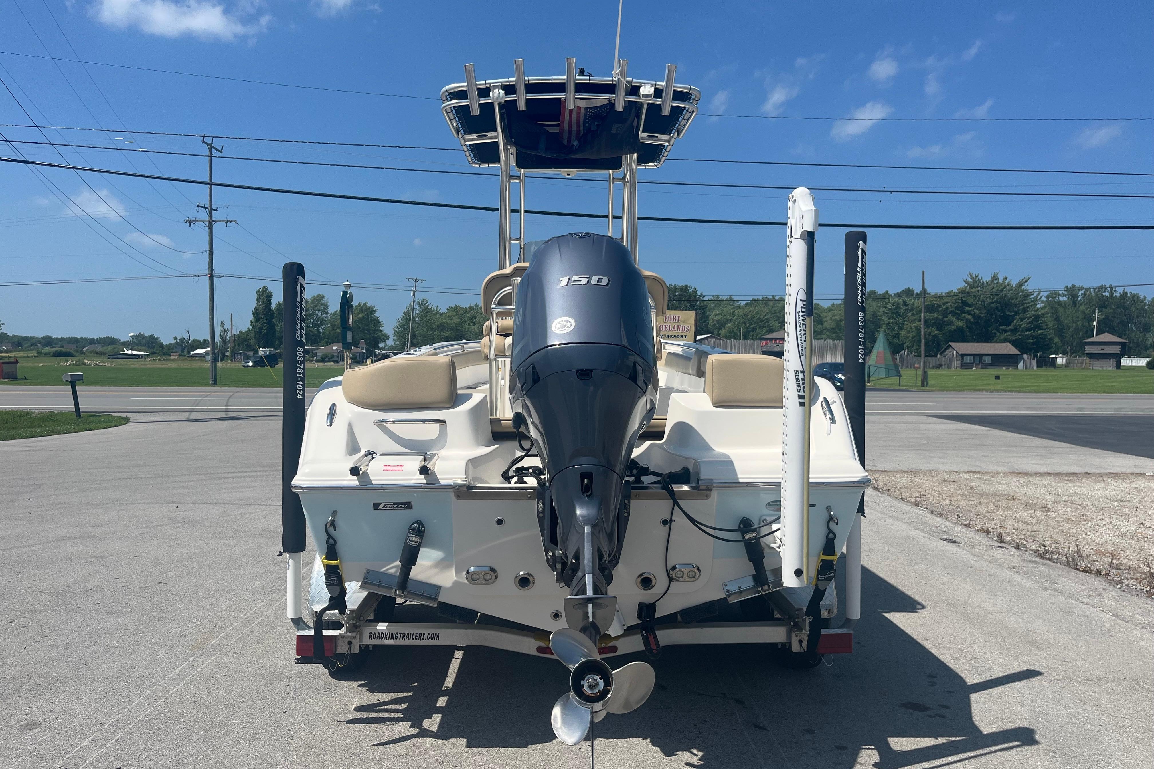 2017 Key West 203 FS boat with Yamaha 150 engine, parked on a sunny day.