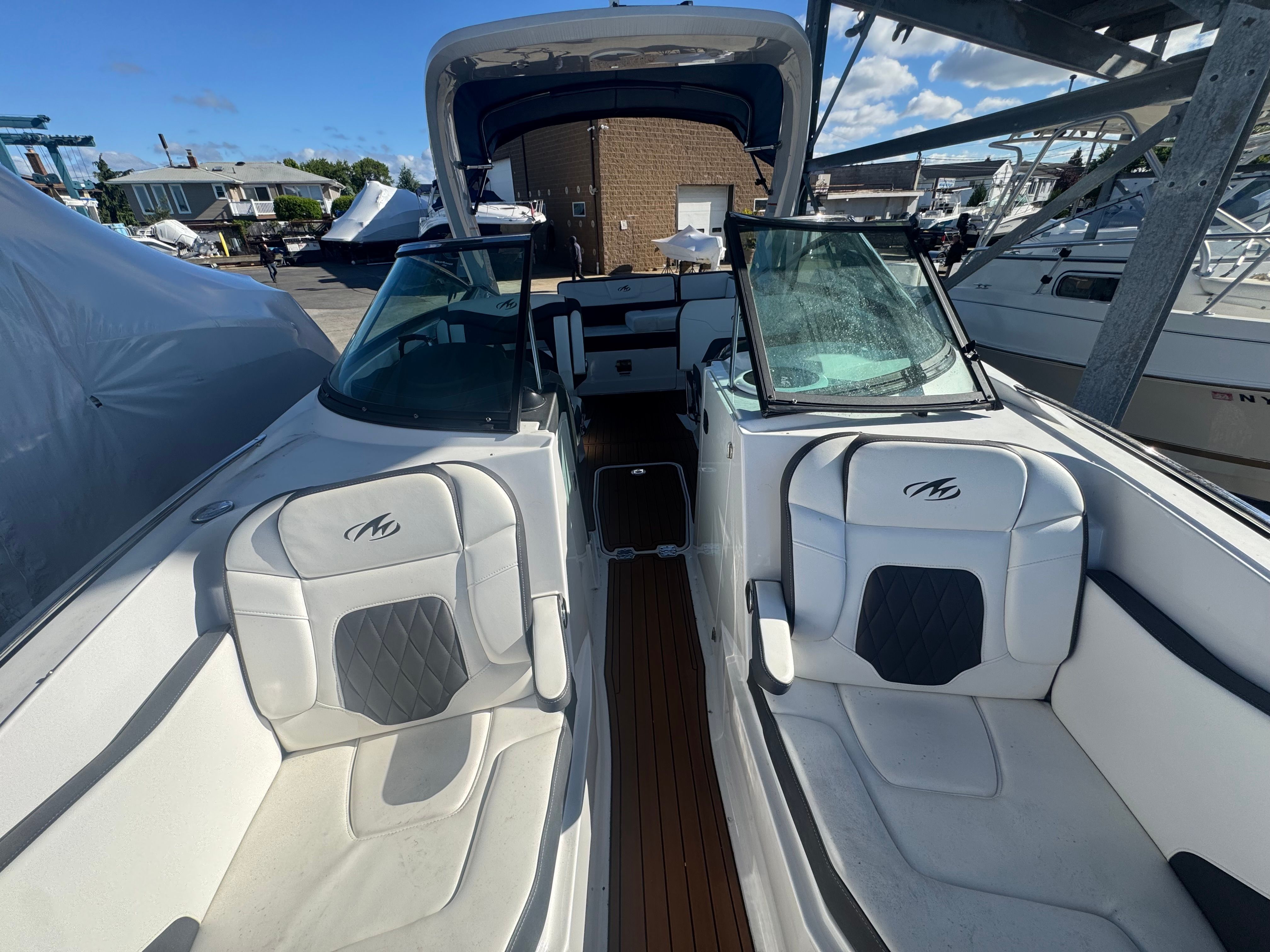 The image shows the cockpit of a 2019 Monterey 298SS Super Sport boat with white seating.