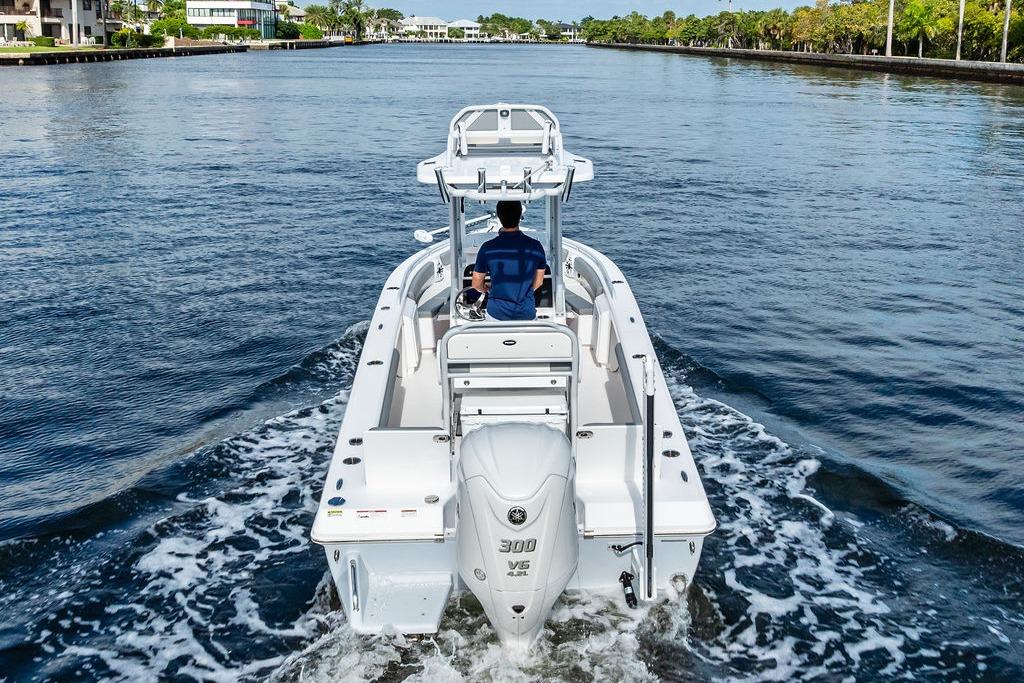 2023 Everglades 243 Center Console boat cruising on a scenic waterway.