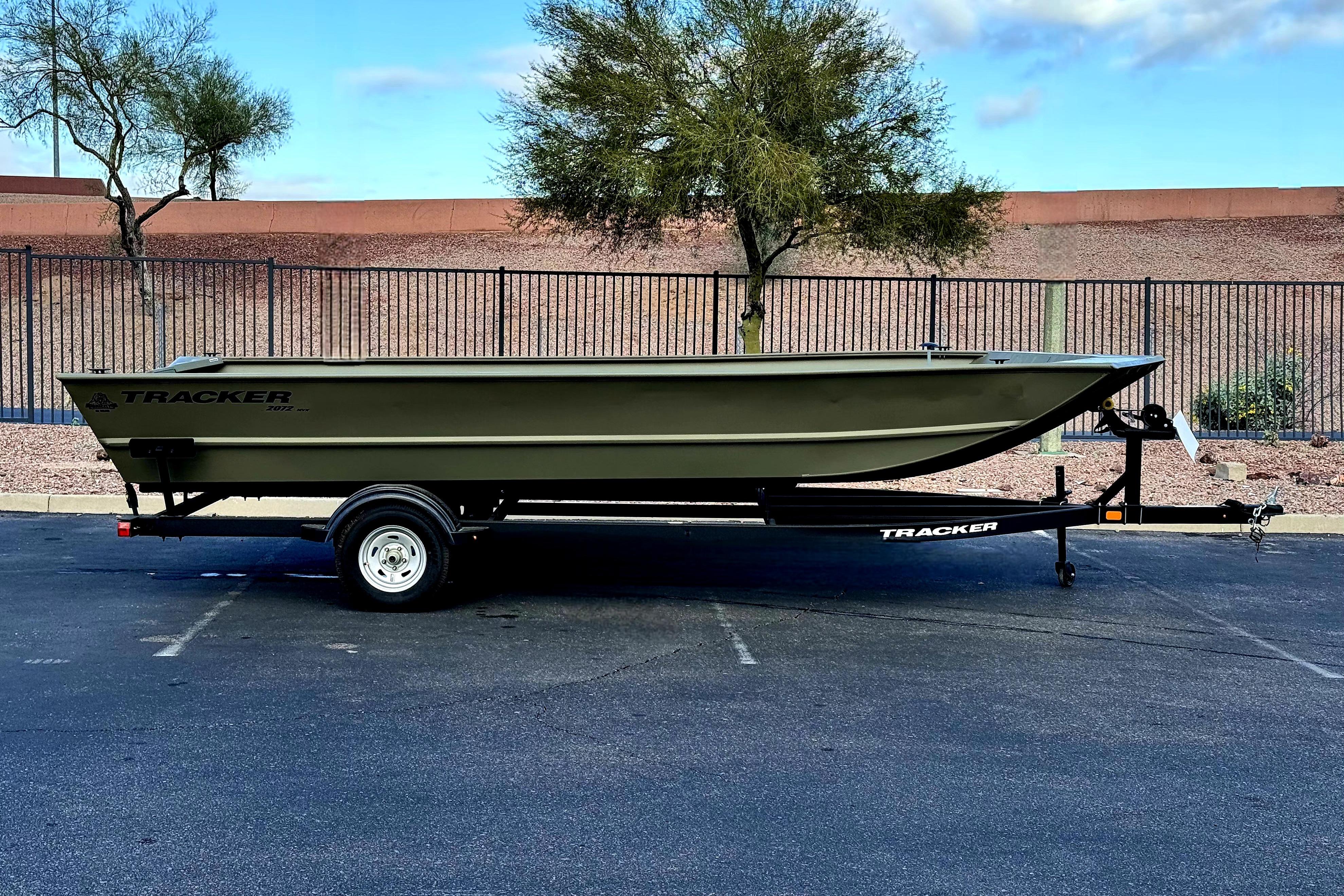 2026 Tracker Grizzly 2072 Utility boat on trailer, parked outdoors.
