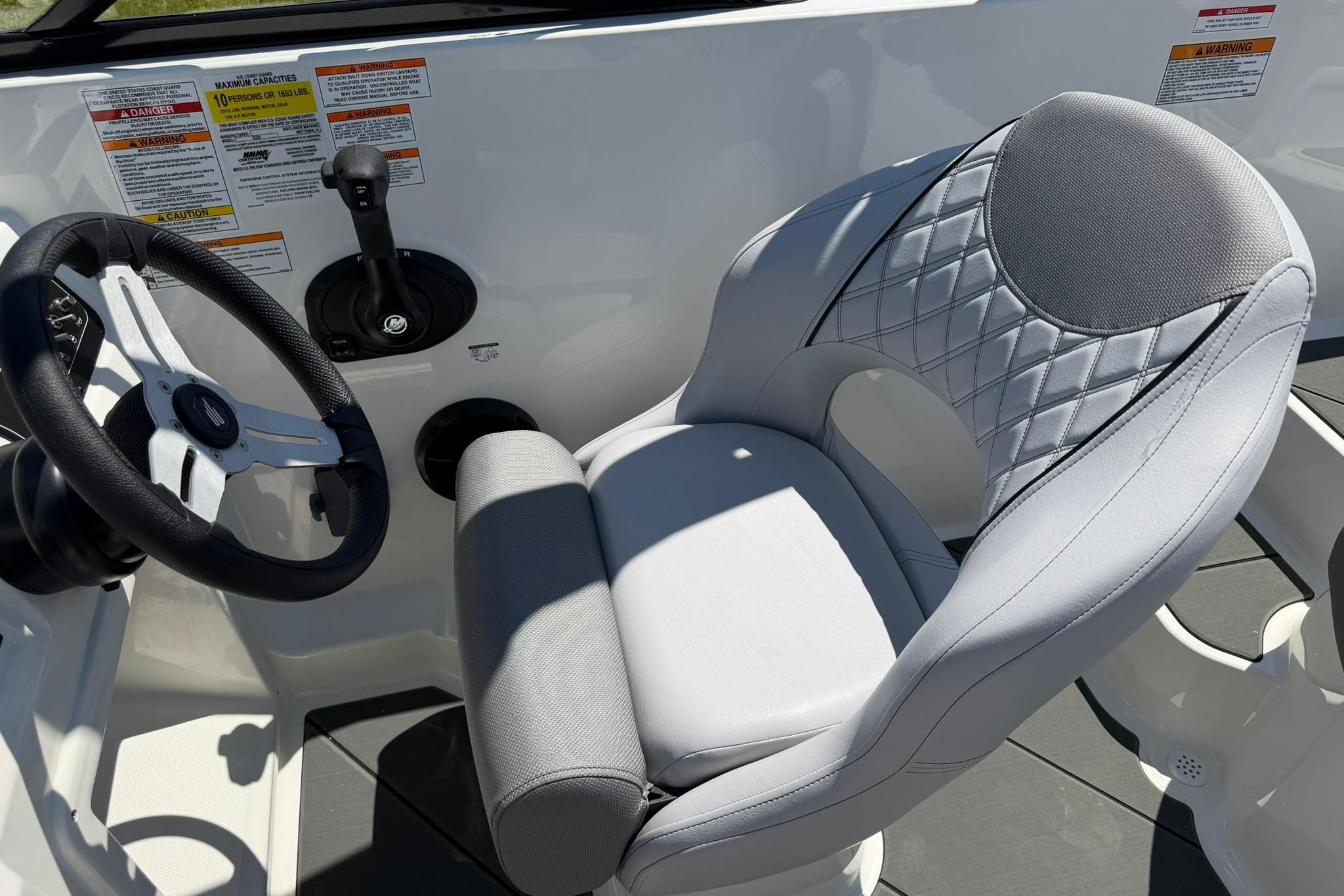 Captain's seat and steering wheel of 2026 Bayliner D20 boat, featuring modern design.