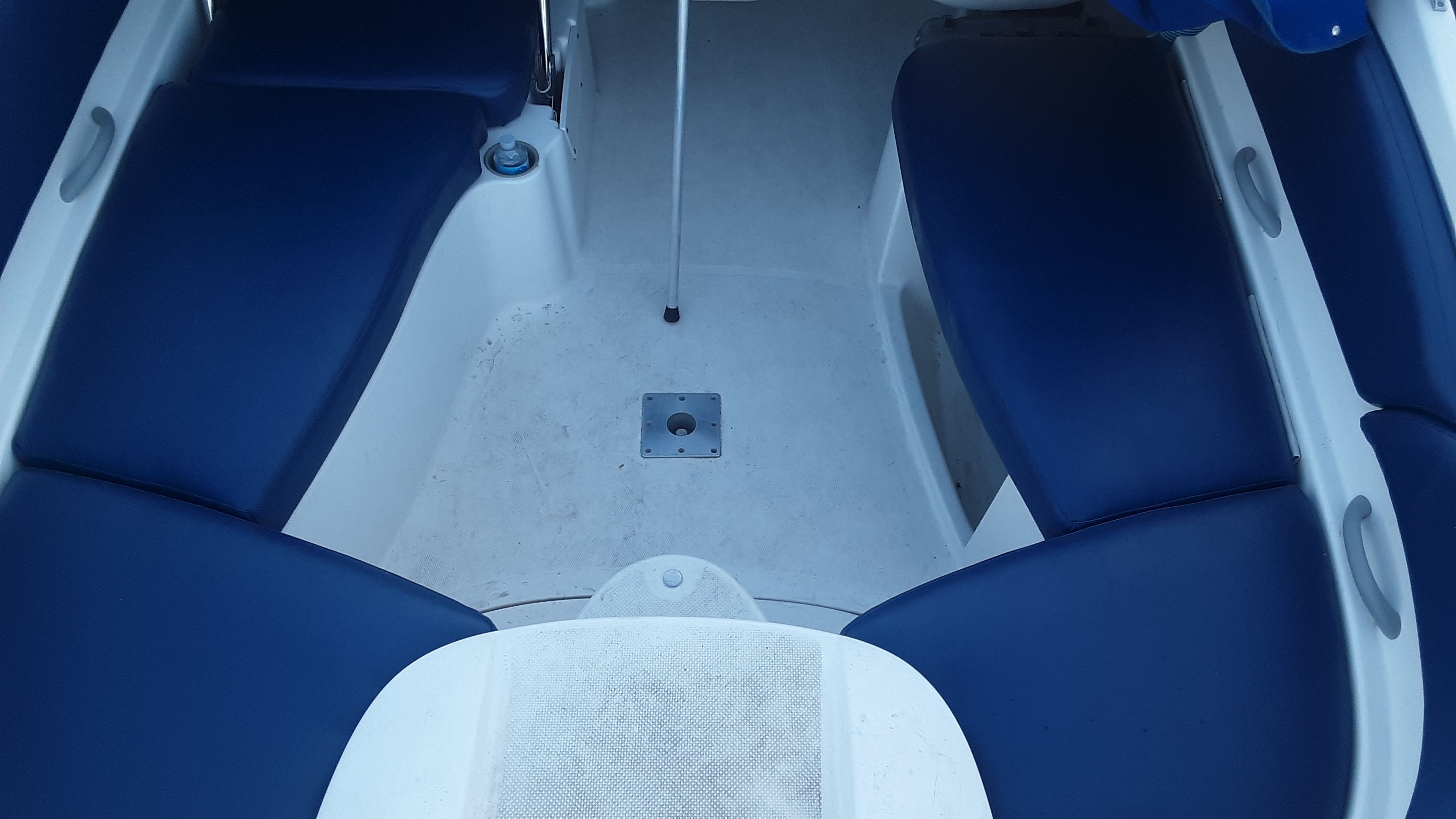 Interior view of a 2005 Bayliner 210 Classic with blue seating.