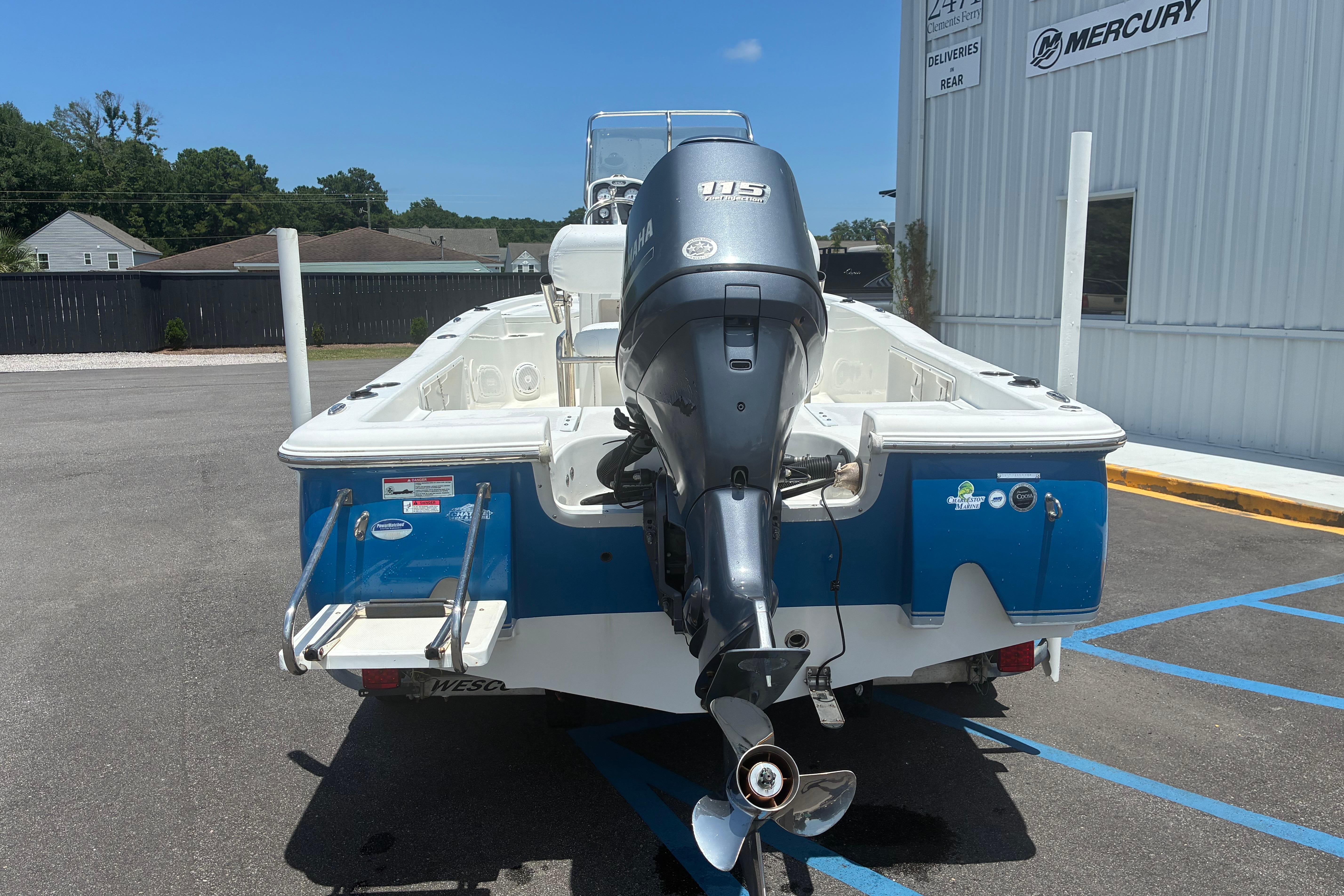 2014 Sea Hunt BX 20 BR boat with Yamaha outboard motor in parking lot.