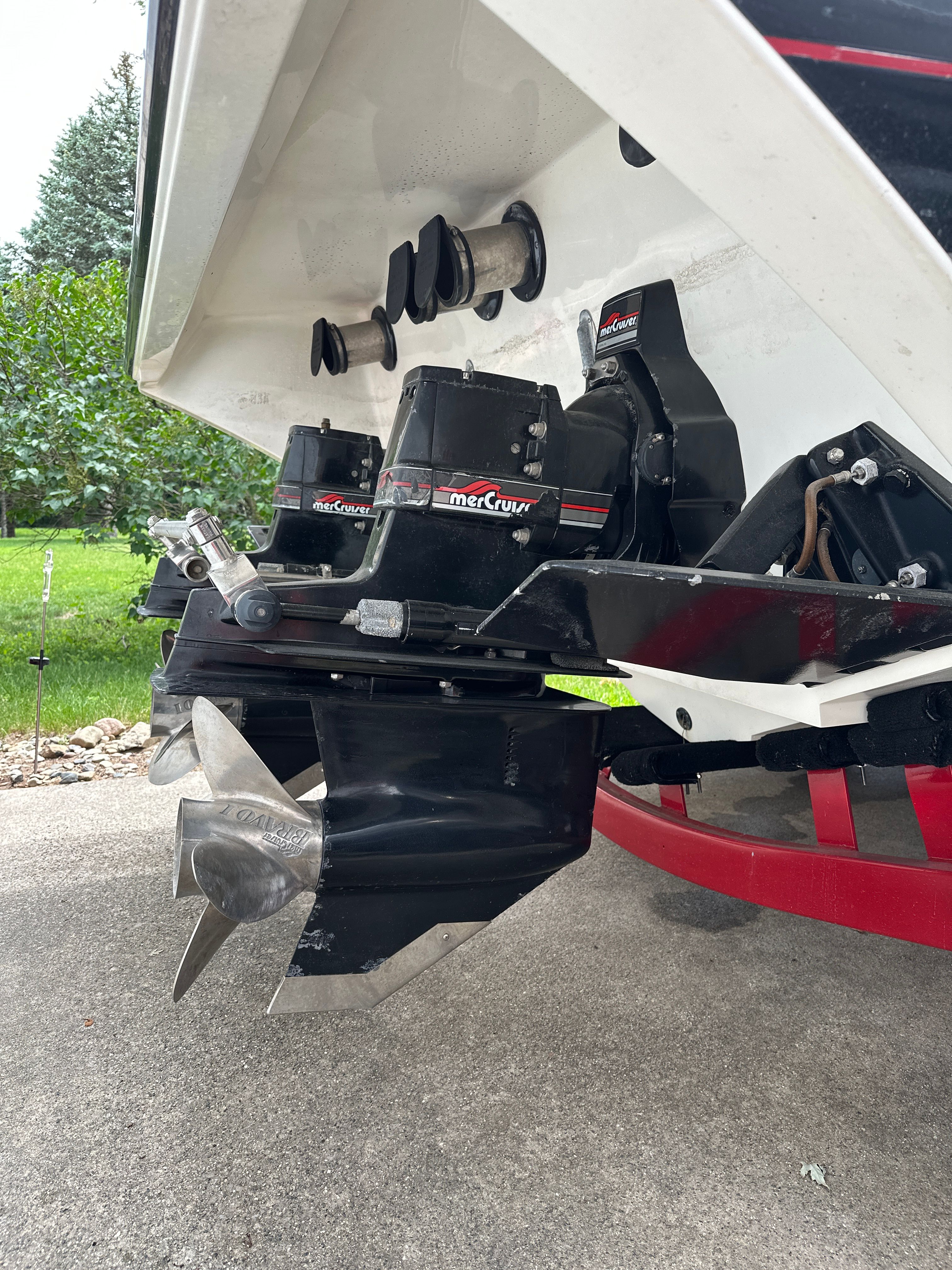 Rear view of a 1994 Fountain Executioner with dual Mercury drives and propellers on a concrete surface.
