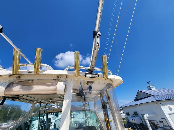 2005 Pursuit 3070 Offshore Center Console boat under clear blue sky.