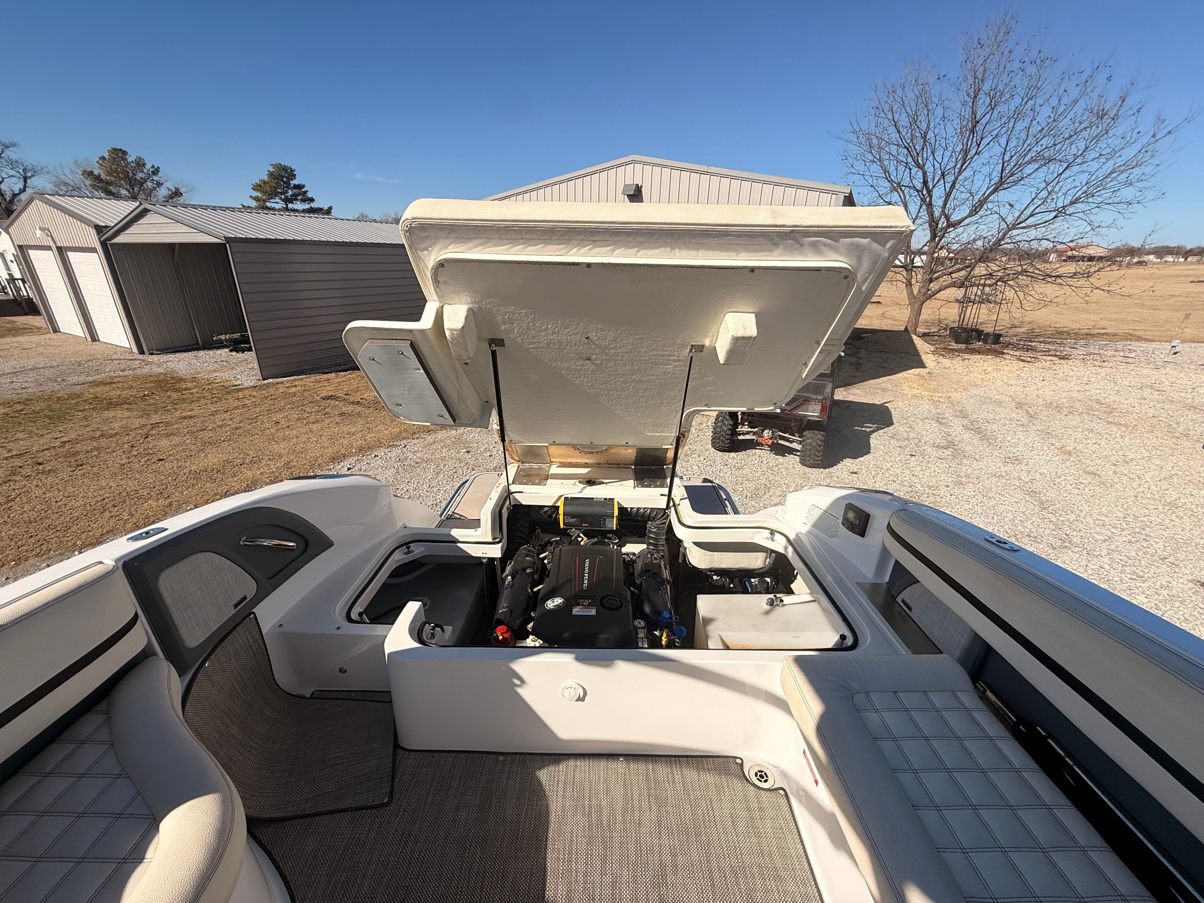 A 2019 Cobalt R7 Surf with an open engine cover, revealing the engine compartment and surrounding seats.