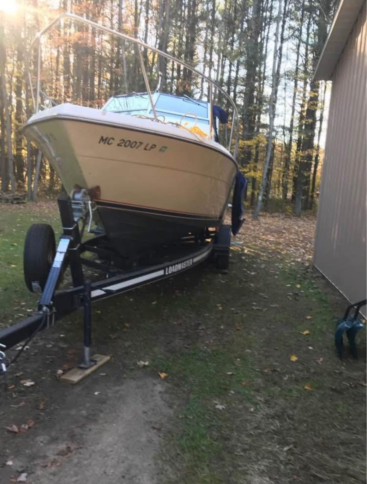 1984 Tiara Yachts PURSUIT 2600 on trailer in wooded area.