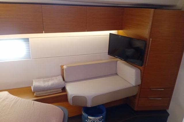 Interior of 2022 Hanse 460 yacht with modern seating and wall-mounted TV.