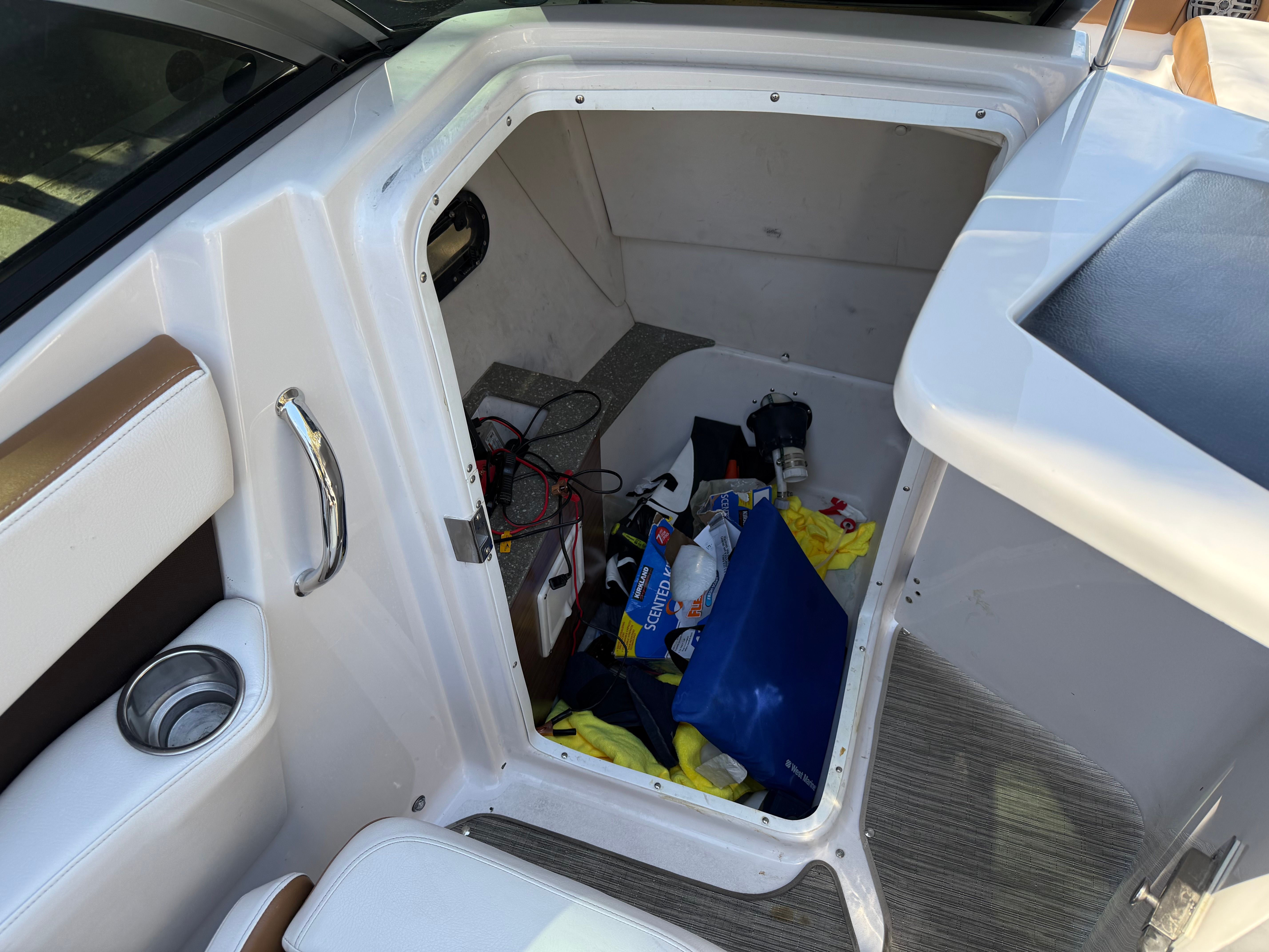 Storage compartment in 2019 Four Winns H260 boat with accessories.