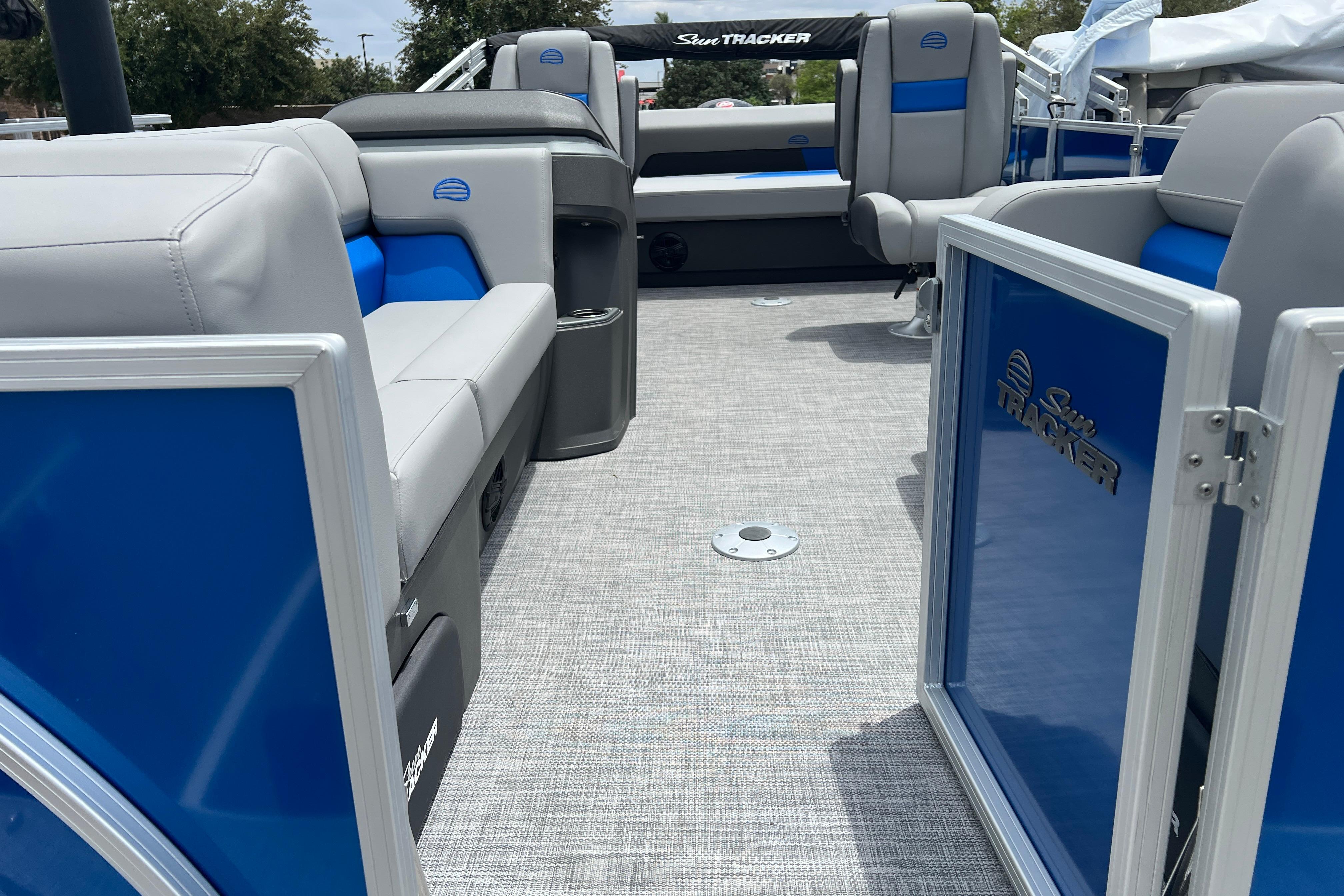 2026 Sun Tracker Party Barge 22 RF DLX interior with blue and gray seating.