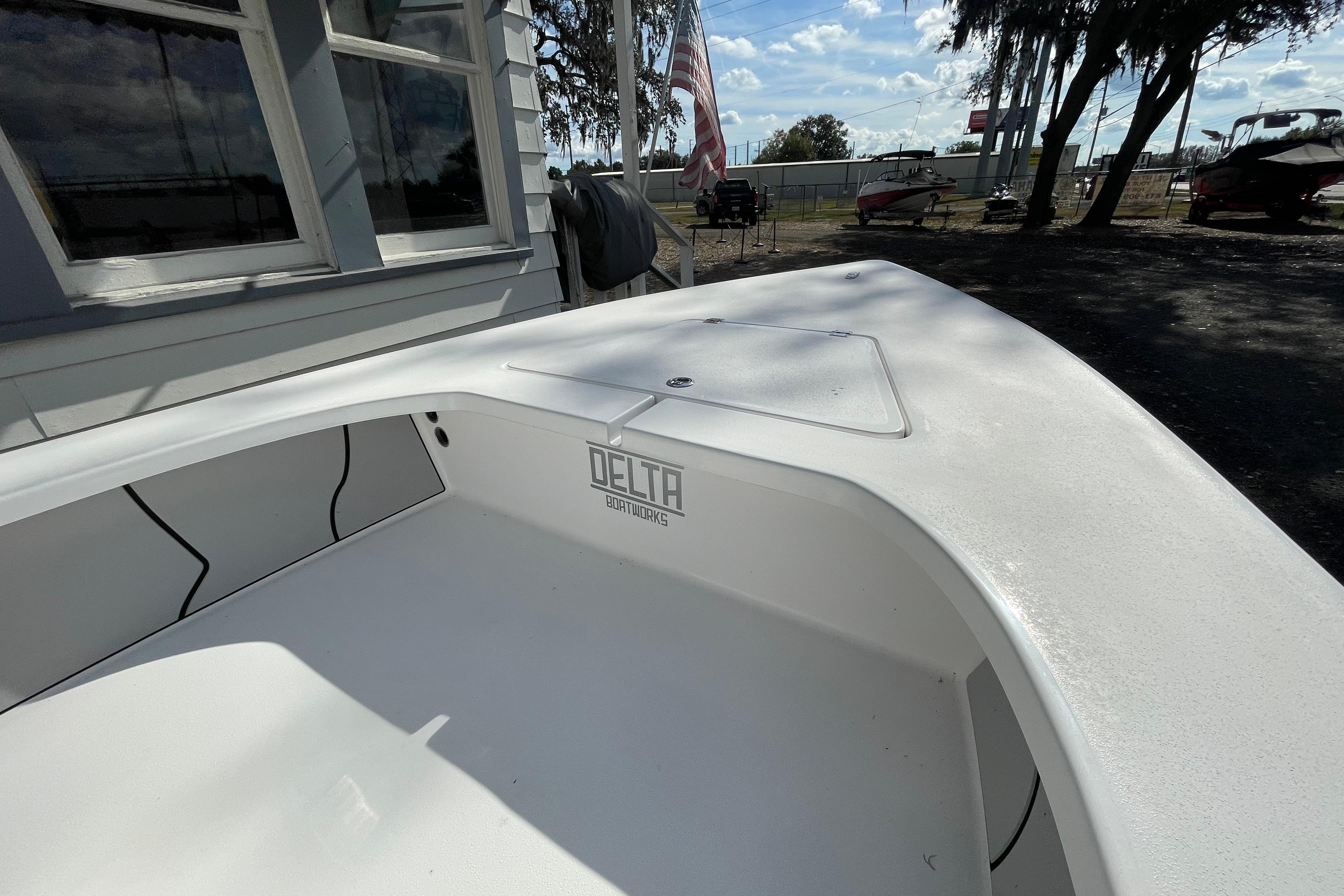 2026 Delta Boatworks Delta D18, white interior, docked near a building under a blue sky.