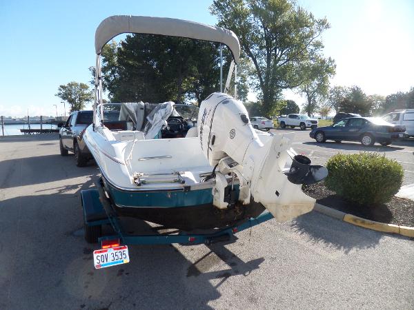 1992 Rinker Captiva 170 OB boat on trailer in parking lot.