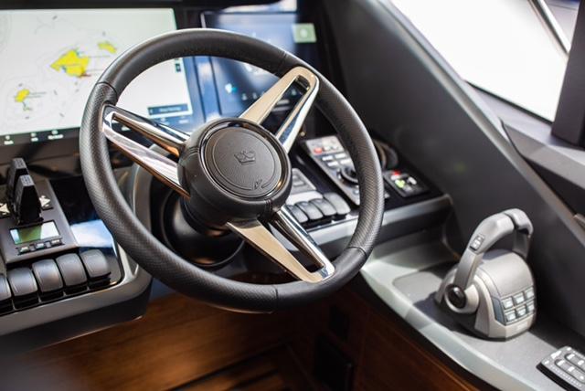 2024 Princess V55 yacht helm with modern steering wheel and navigation controls.
