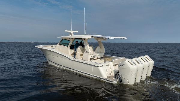2025 Scout 425 LXF boat cruising on open water with multiple outboard engines.