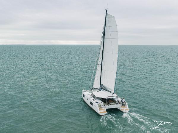 2025 Nautitech 40 Open catamaran sailing on open sea under cloudy skies.