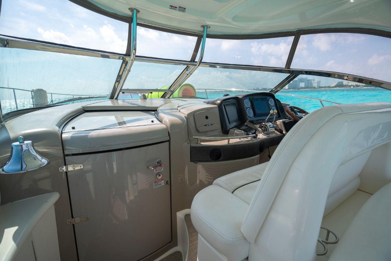 Helm of 2006 Sea Ray 440 Sundancer yacht with modern controls and ocean view.