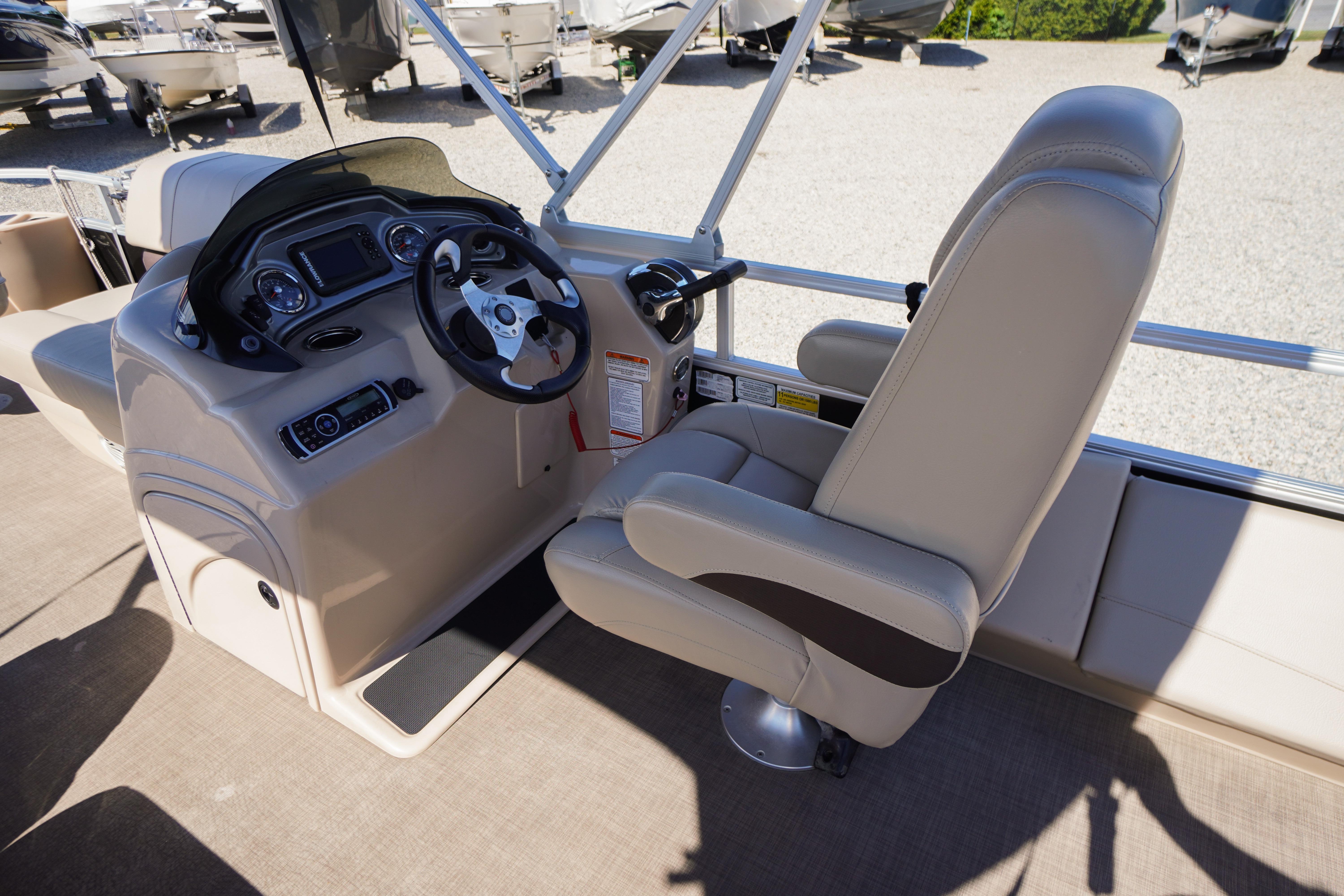 2019 SUNTRACKER Fishin' Barge 22 DLX boat interior with steering console and captain's chair.