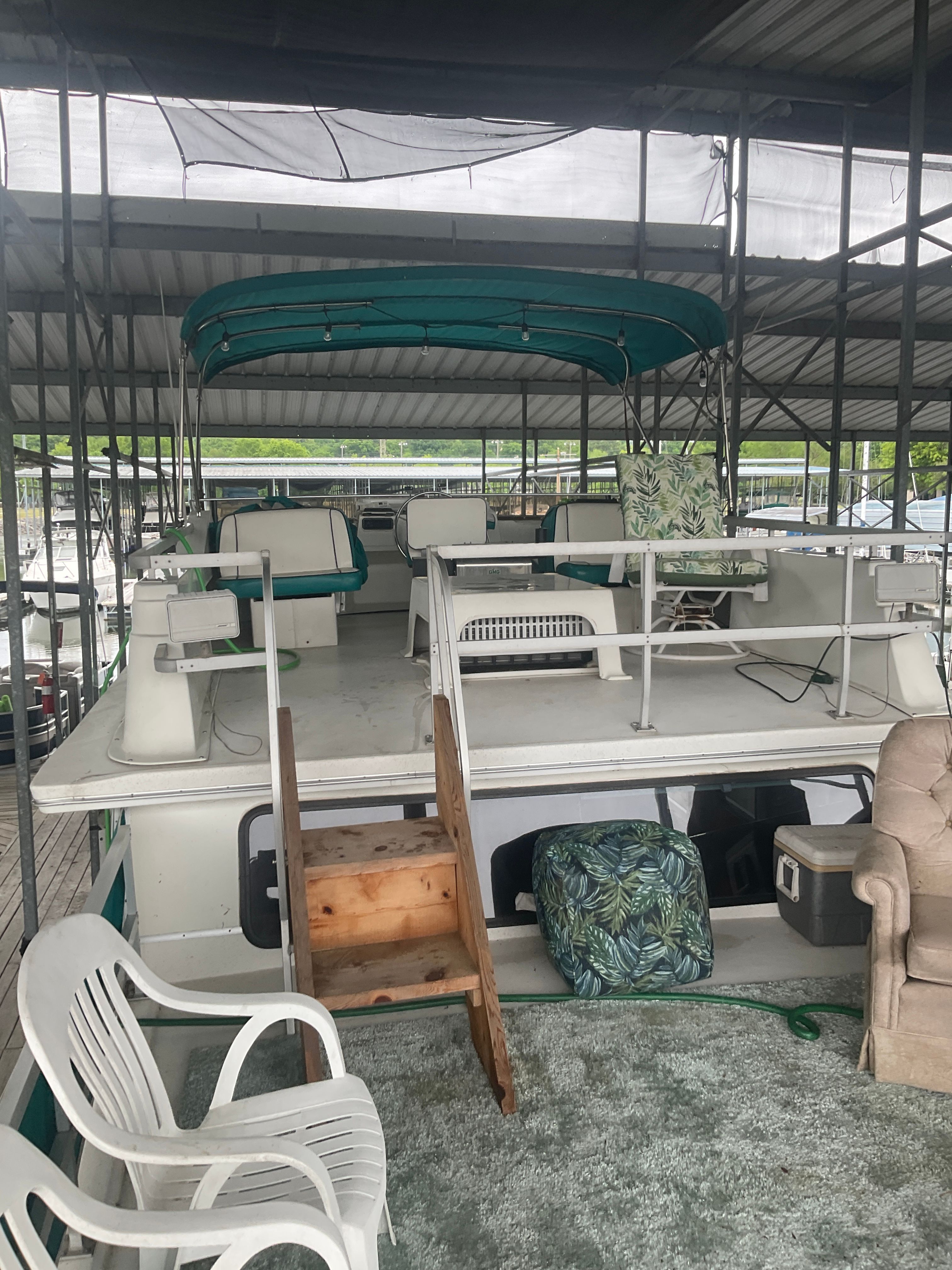 A 1996 Gibson 44 Standard houseboat with a covered upper deck and outdoor seating.