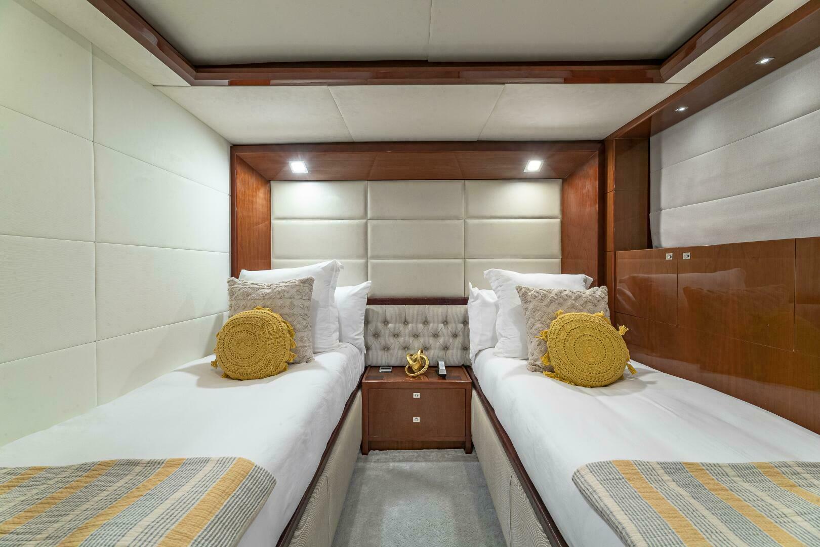 Luxurious twin cabin interior of 2012 Princess 32M yacht with modern decor.